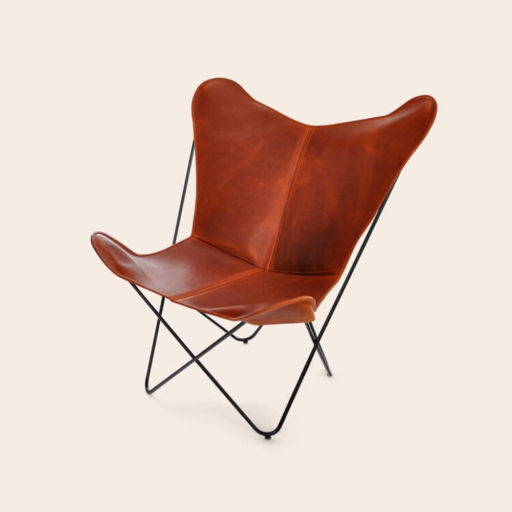Cognac papillon chair by OxDenmarq
Dimensions: D 90 x W 78 x H 97 cm
Materials: Leather, Stainless Steel
Also Available: Different leather colors available.

OX DENMARQ is a Danish design brand aspiring to make beautiful handmade furniture,