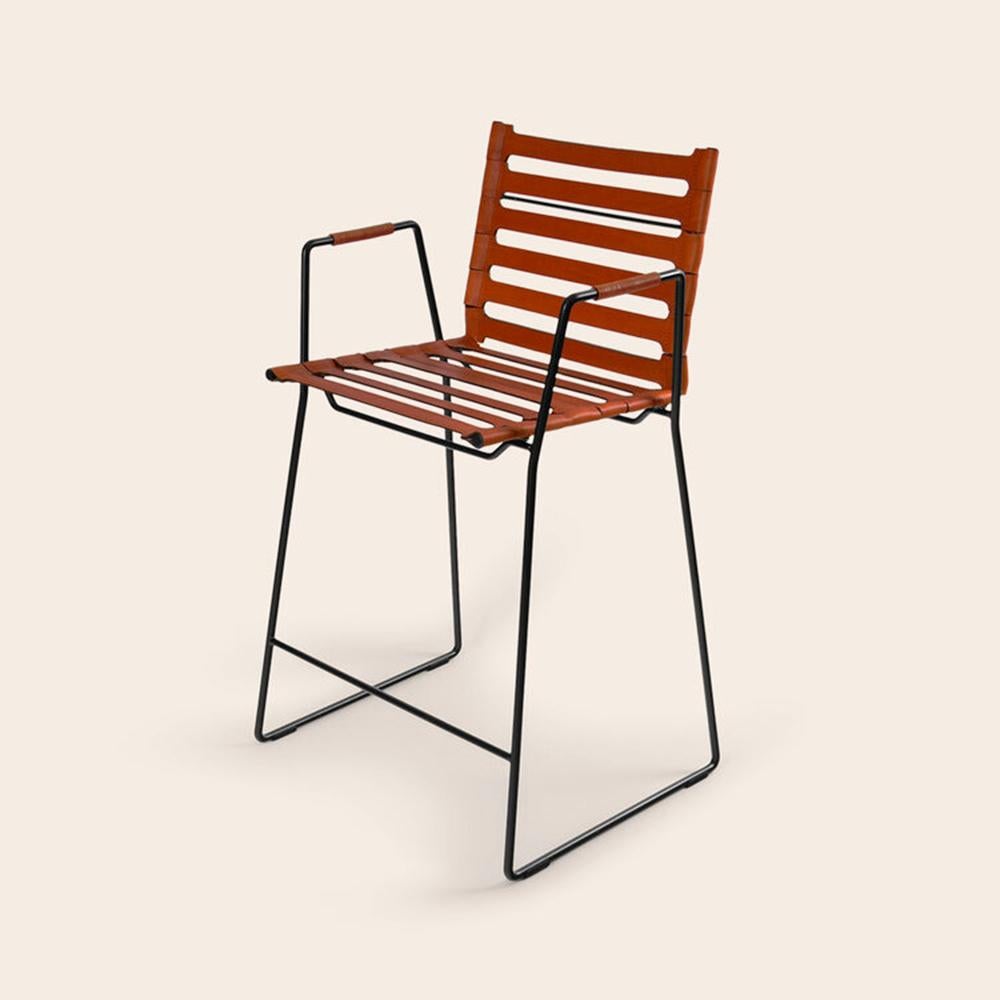 Cognac strap bar chair by OxDenmarq
Dimensions: D 45 x W 45 x H 104 cm
Materials: Leather, black powder coated steel
Also available: Different colors available

OX DENMARQ is a Danish design brand aspiring to make beautiful handmade furniture,