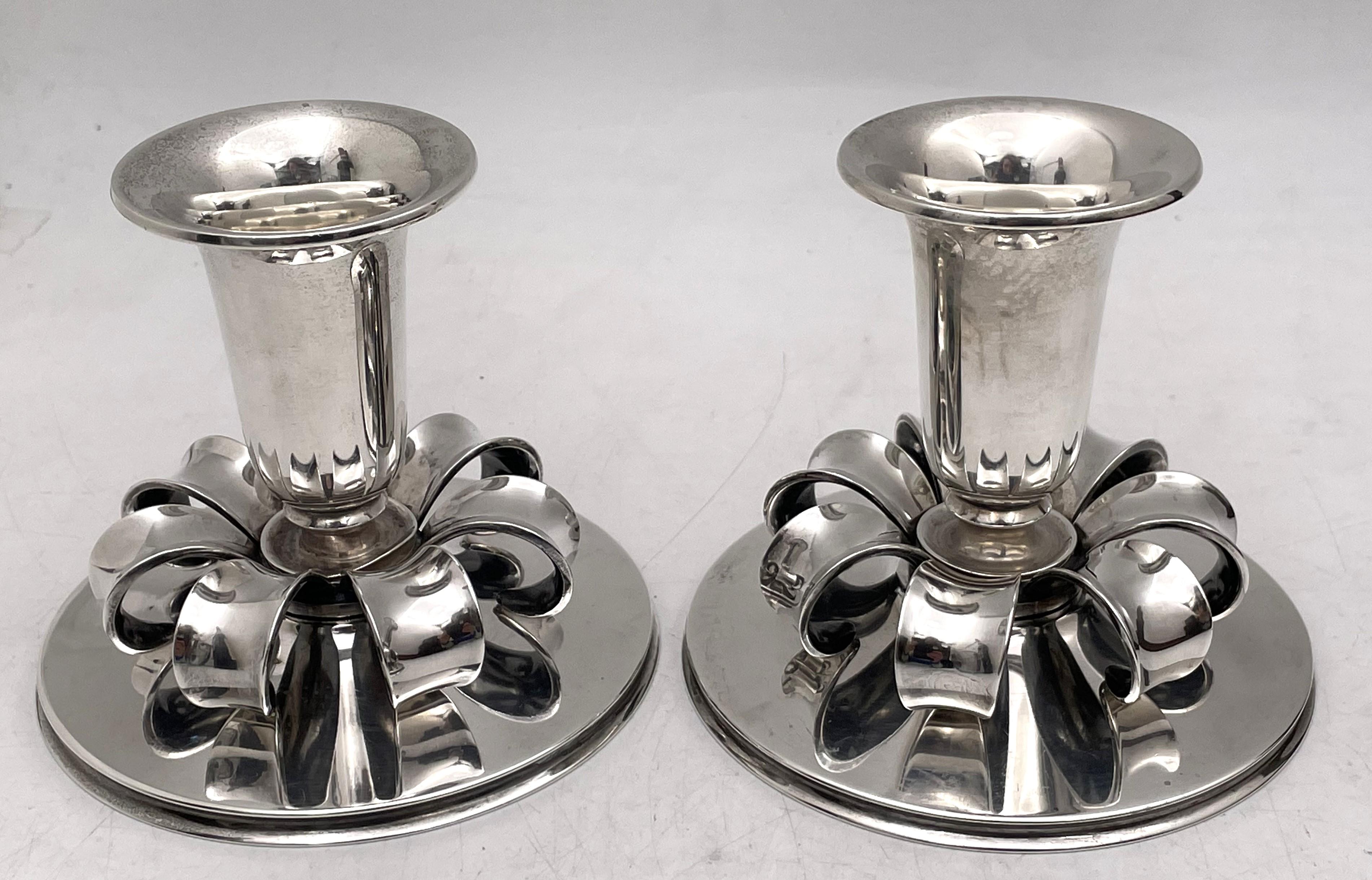 Cohr, Danish pair of sterling silver oil candlesticks in an elegant, geometric, Mid-Century Modern style as well as in a quality and style reminiscent of Georg Jensen. They measure 3 1/3'' in height by 3 7/8'' in diameter at the base and bear