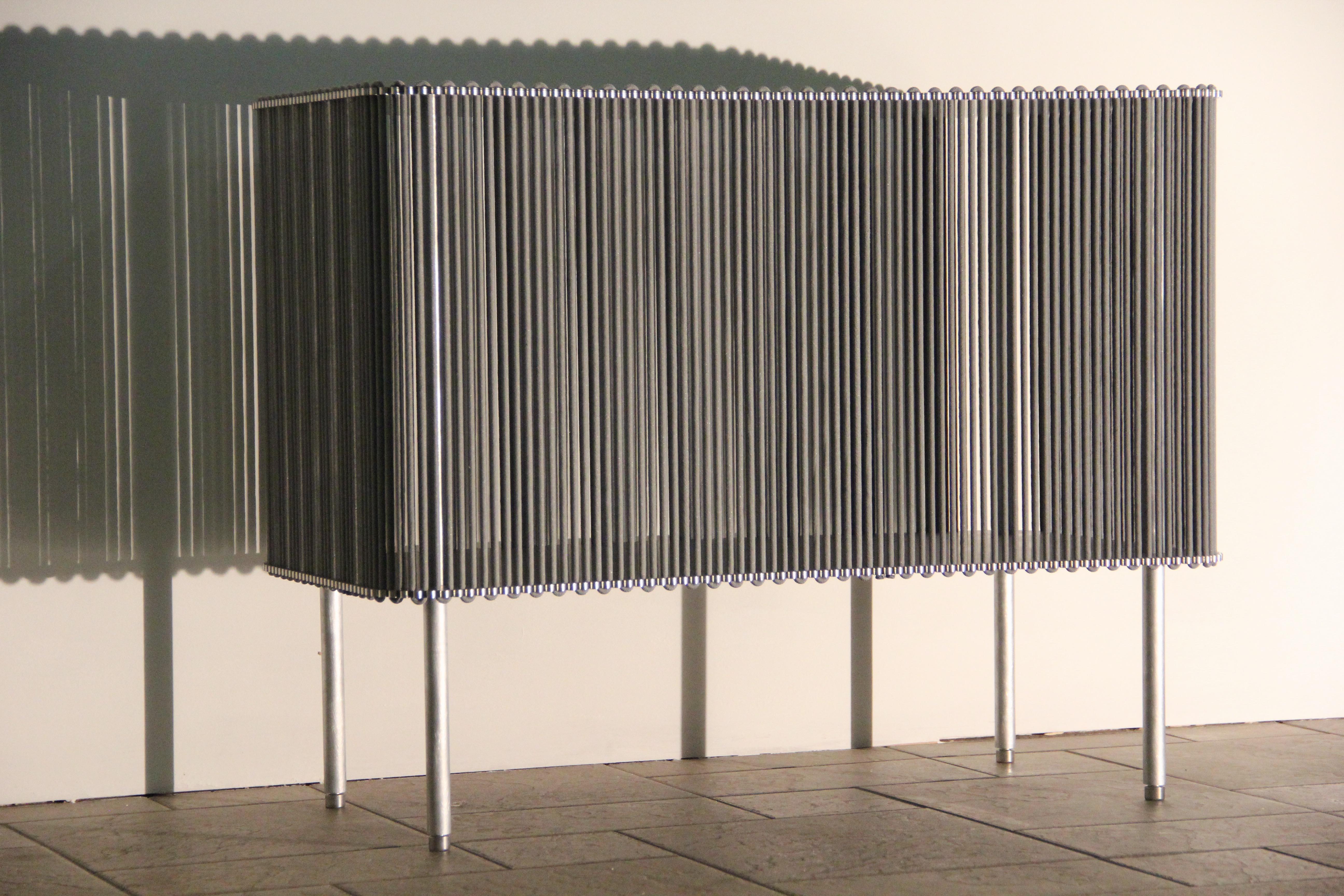 Coil #1 low cabinet by Bram Kerkhofs.
Dimensions: H 63.5 x L 80 x W 40 cm
Materials: Stainless steel, aluminium, elastic rope (natural rubber, polyethylene).

Other dimensions are available.

COIL is a modular cabinet system in which the