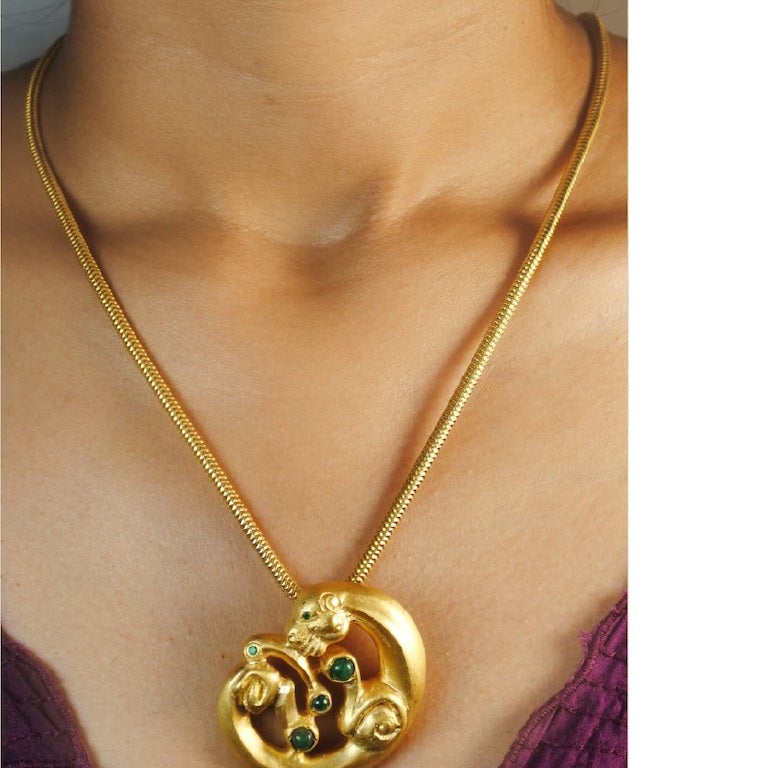 Inspired by the Central Andes, Peru, circa 1200 BC, this exquisite pendant echoes the Panther Mouth Mask of the Cupisnique/Chavín culture. Feline predators, key motifs in this culture, are depicted in a stylized, exaggerated, and unrealistic manner,
