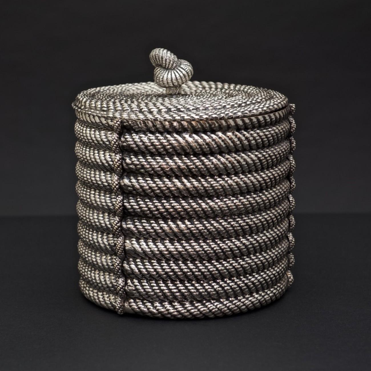 A stylish silver plated ice bucket or wine cooler of cylindrical design in the form of coiled rope with matching lid, by Spanish maker Valenti; circa 1975. The inside liner is insulated to help keep things cool.

Dimensions: 22cm/8¼ inches (height)