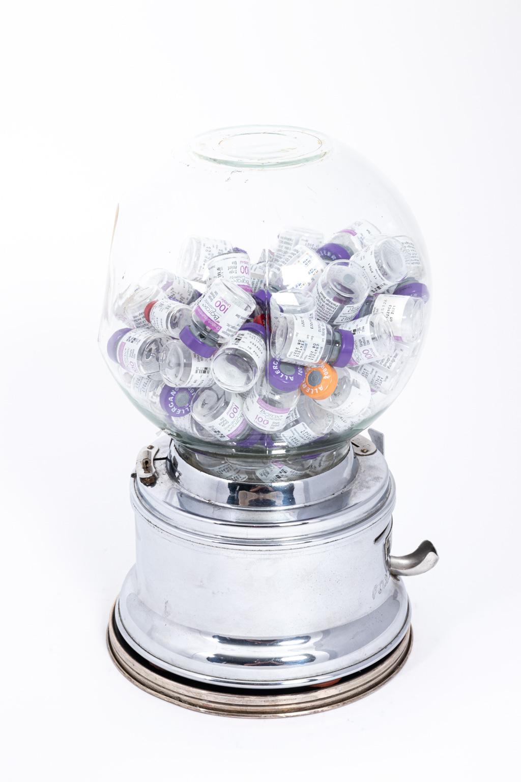 Vintage 1960s Gumball machine filled with empty Botox containers. Art piece, complete with key. Glass circumference is 24.00 inches.