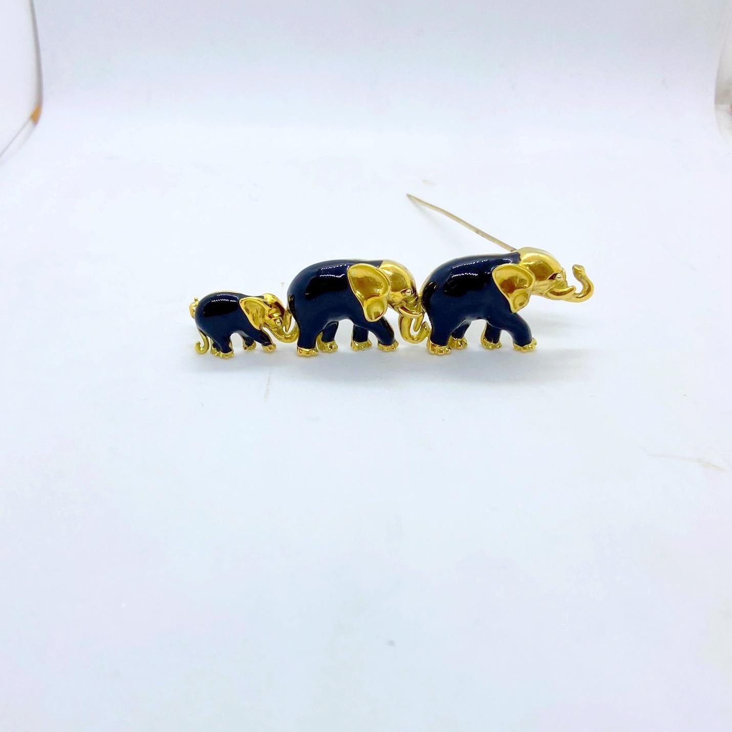 1This beautiful 18 karat yellow gold elephant brooch designed by Coin Roberto Italy. This brooch is composed  of a family of 3 elephants ,each with black enamel. The elephants have their tusks up for good luck!
the brooch measures 3