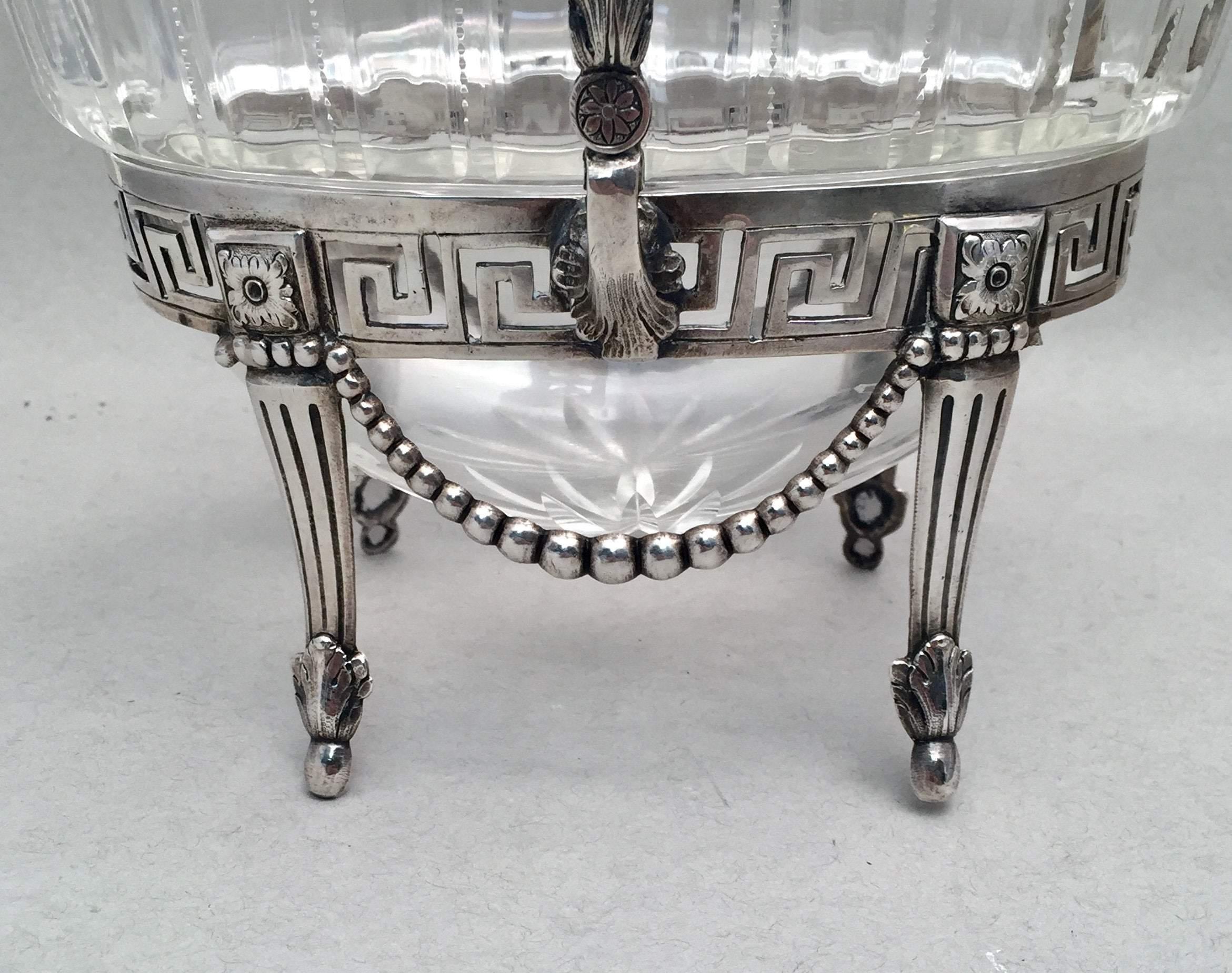 A beautiful coin silver bridal basket with a removable glass insert. Standing on four feet with leaf pattern. Measuring 7 1/5 inches tall and 6 1/3 inches wide. Unmarked. 

 