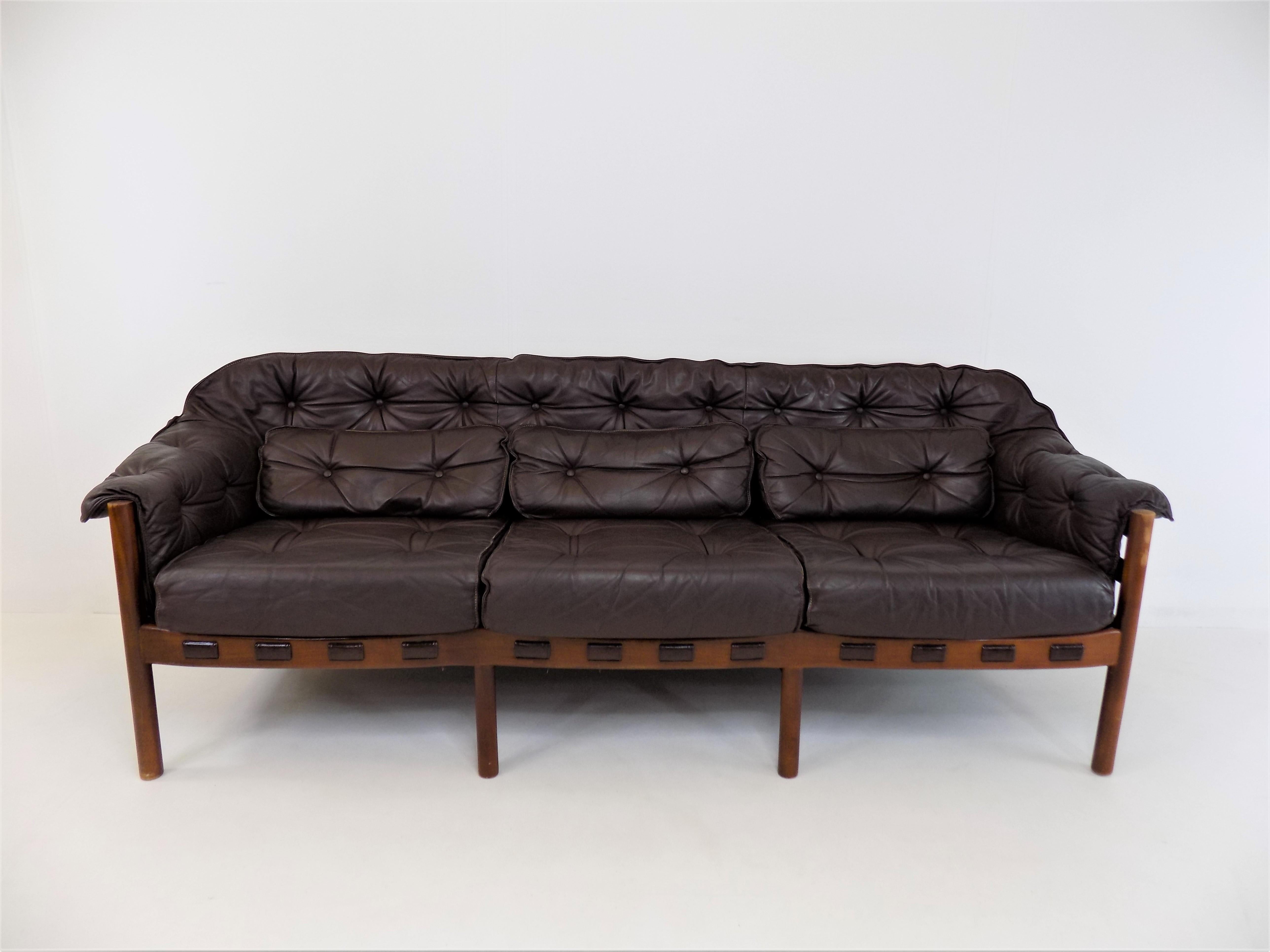 Excellent condition 3 seater leather sofa by the Swedish designer Sven Ellekaer. The chocolate brown leather is in excellent condition. The wooden frame has a beautiful color that harmonises with the leather and shows minimal signs of wear. The