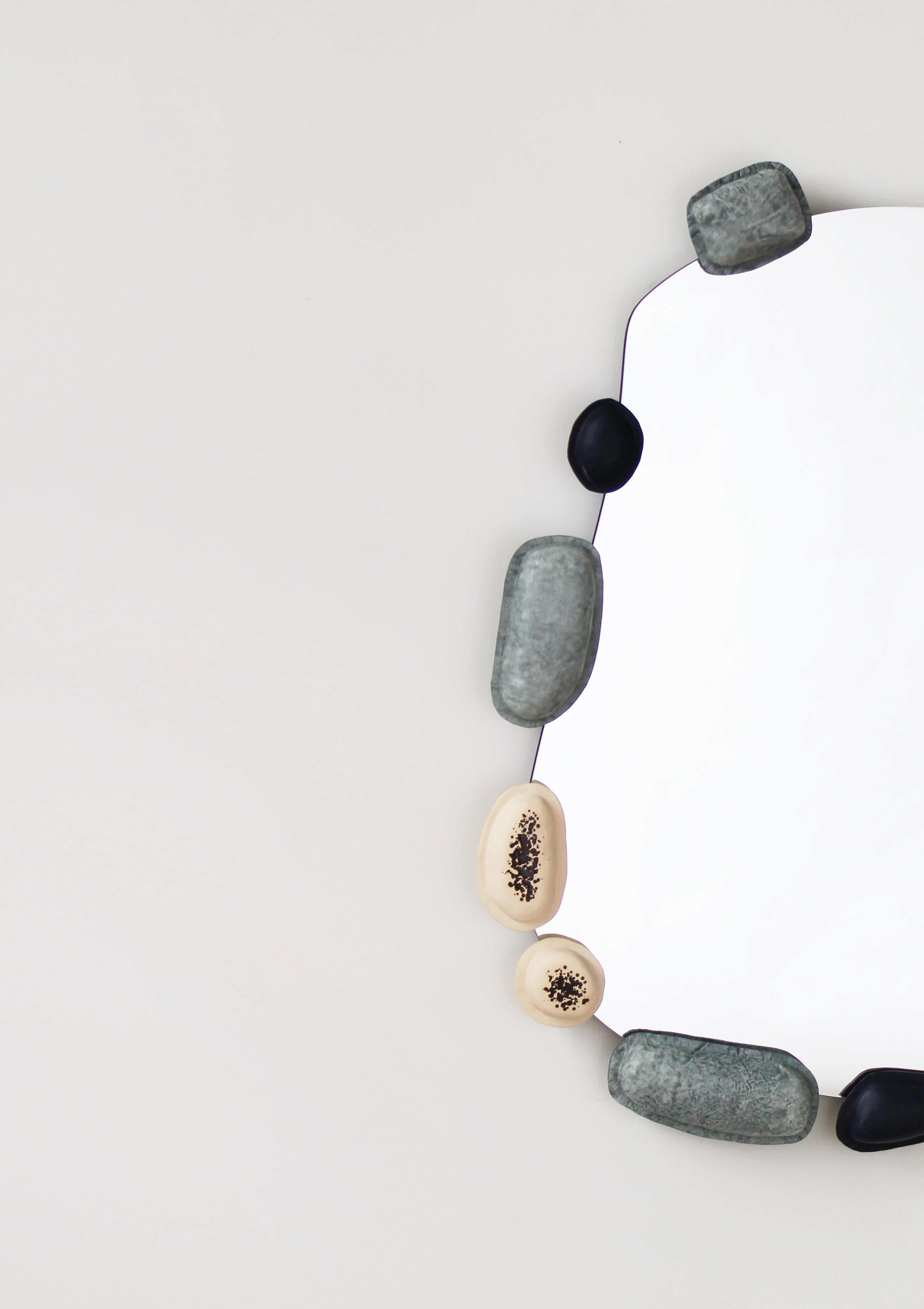 Organic mirror with painted plywood backing. Ceramic, oversized leather formed beads around the mirror.