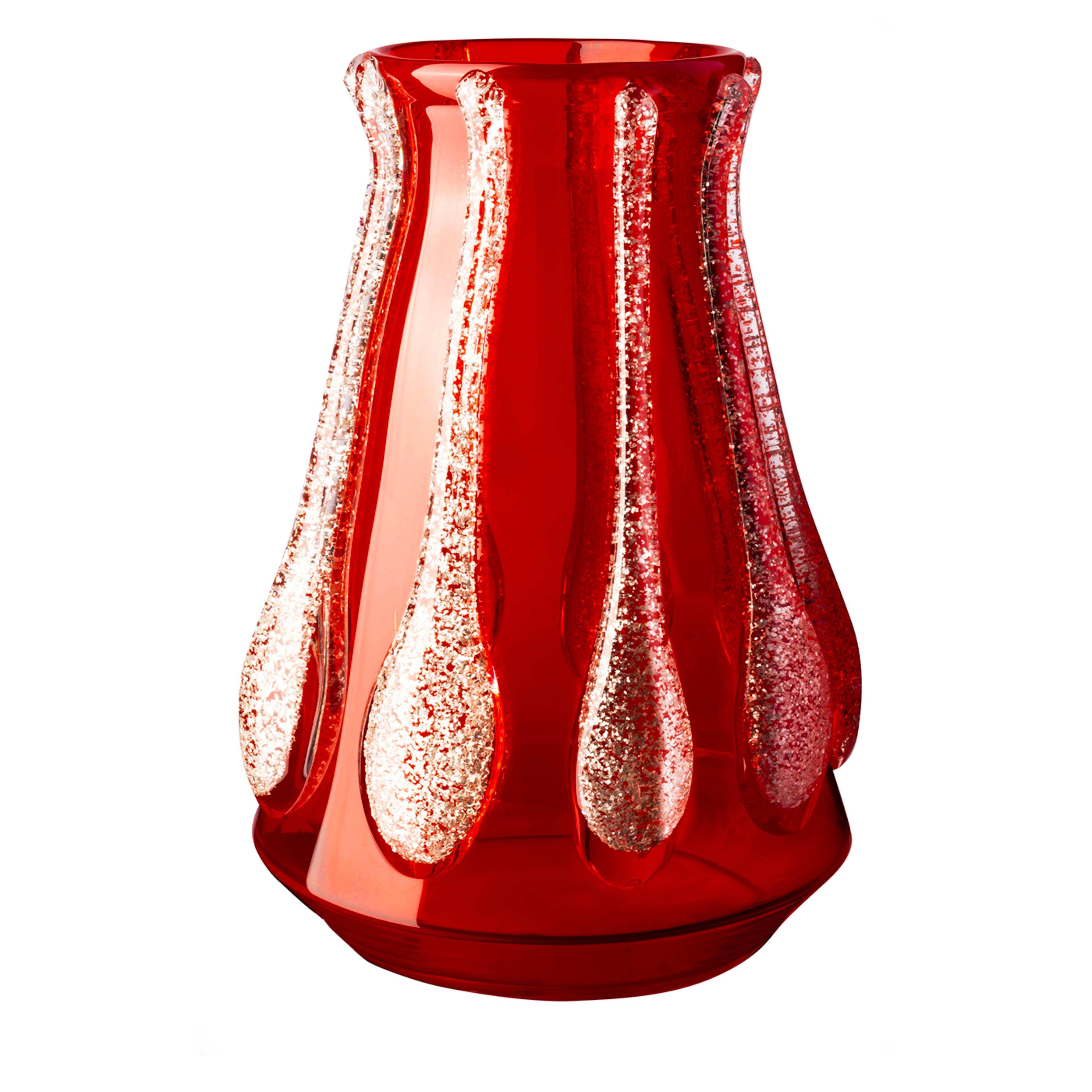 Distilling glamour while exemplifying glassblowing artistry, this vase mouth-blown of prized red Murano glass is a modern version of the iconic Colate Vase. A statement of eccentricity is made by the silvery glitters trapped in the casting-like