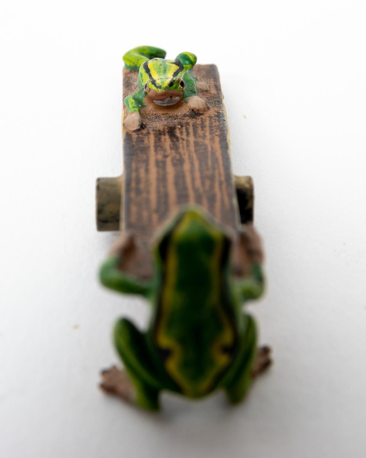 Circa early 20th century cold painted bronze figurines of frogs on seesaw by Franz Bergman. The figurines are signed 