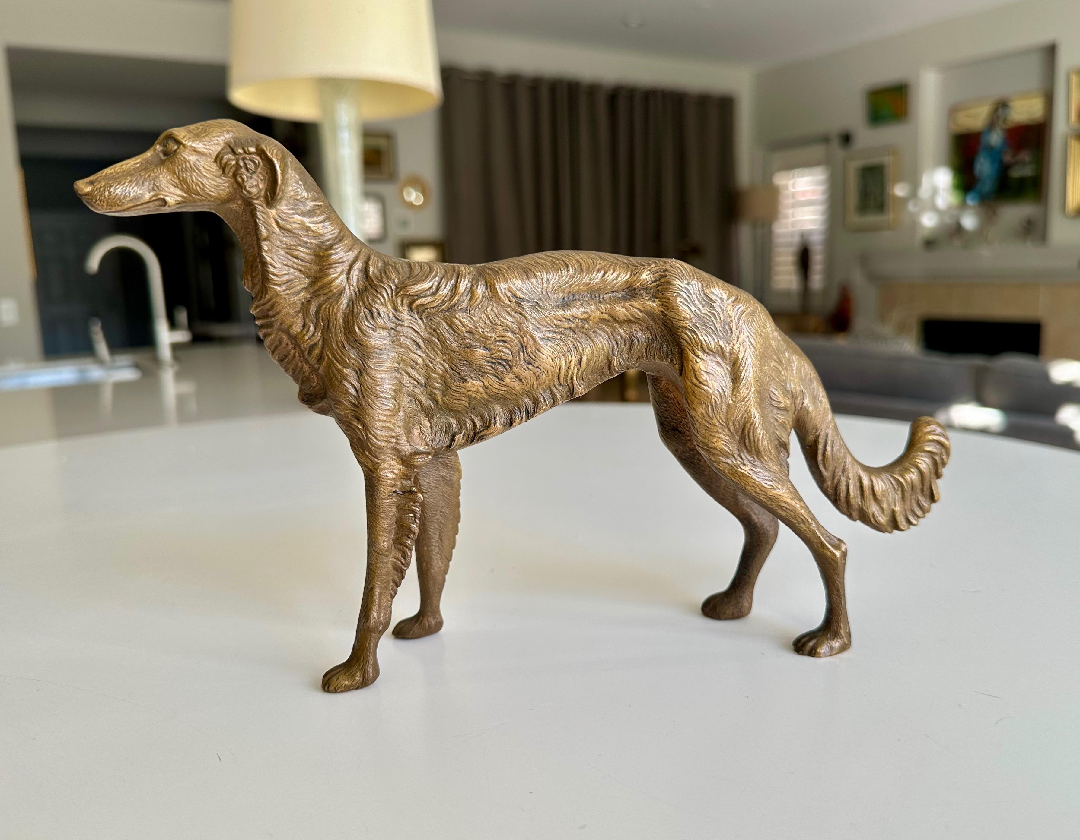 Bronze sculpture of a Borzoi, also known as a Russian Wolfhound. Well executed with fine detailing throughout. The sculpture is approximately 7 inches high by 10 inches wide. 
It depicts the dog in a standing pose with a curled tail. The bronze
