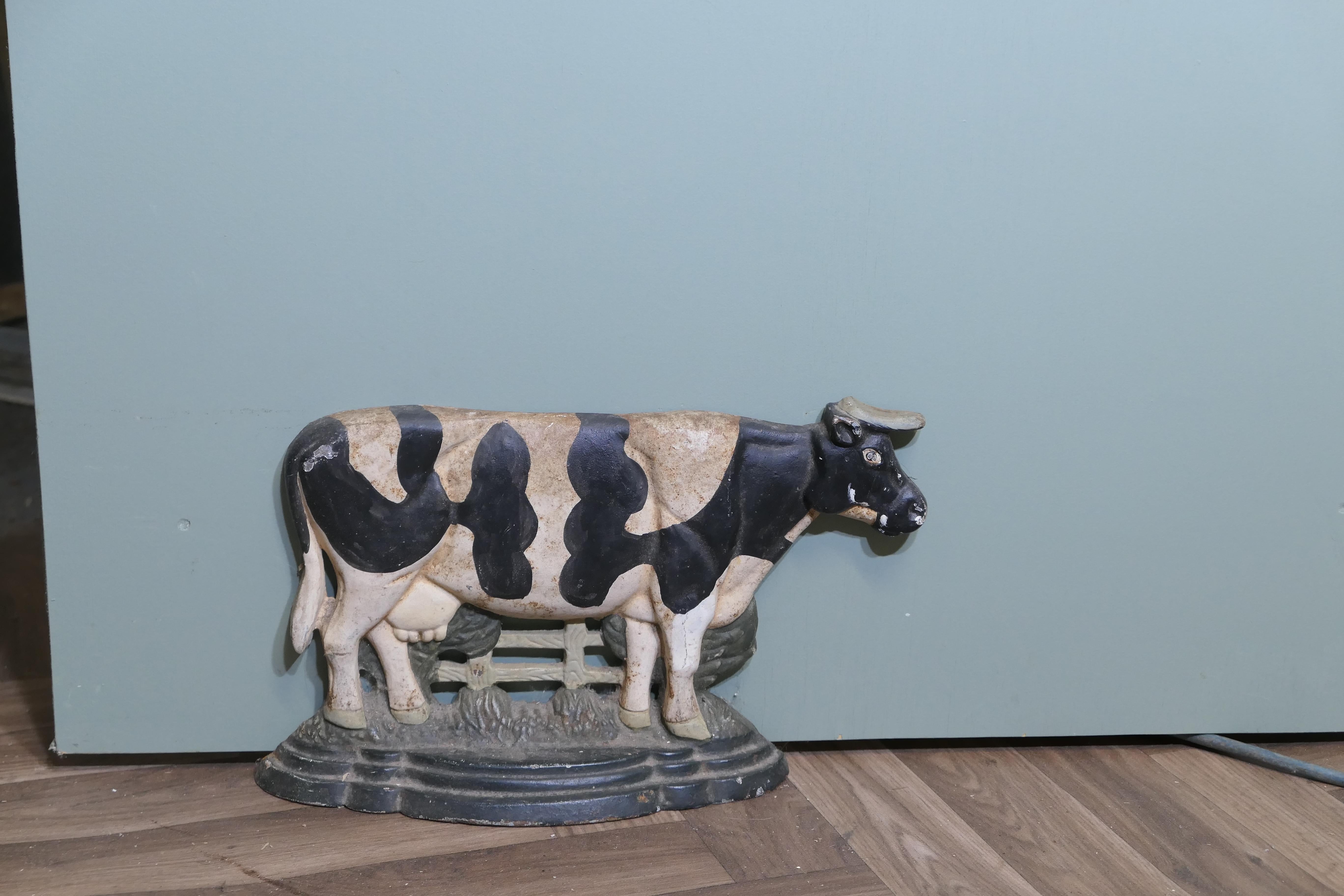 Cold Painted Cast Iron Door Stop, Cow at the Gate

Needless to say a heavy piece, the finish has slightly rusted with age, a black and white cow by the gate 
All in good sound condition with aged patination
The stop is 8” high, 14” wide and 3”