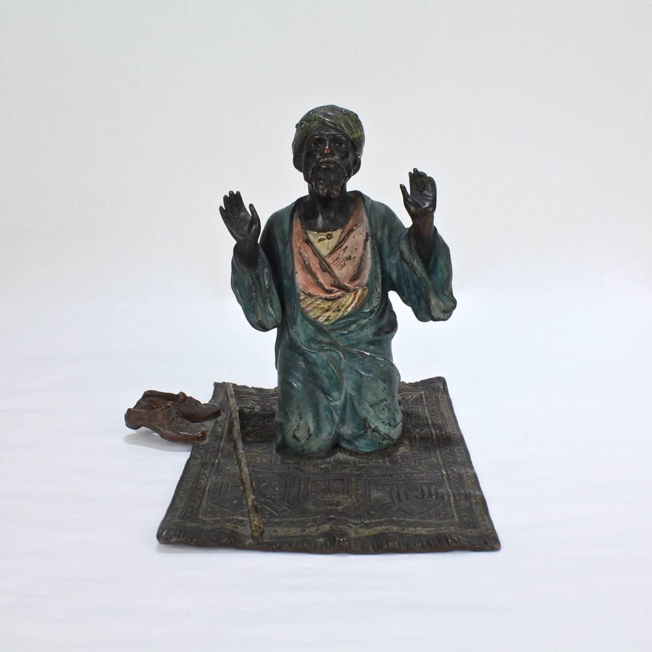 A fine, antique cold-painted orientalist bronze by Franz Bergmann from the Bergmann factory and from the original, early production period.

Depicting an Arab man in prayer on a rug with shoes and walking stick.

Underside marked GESCHUTZT and with