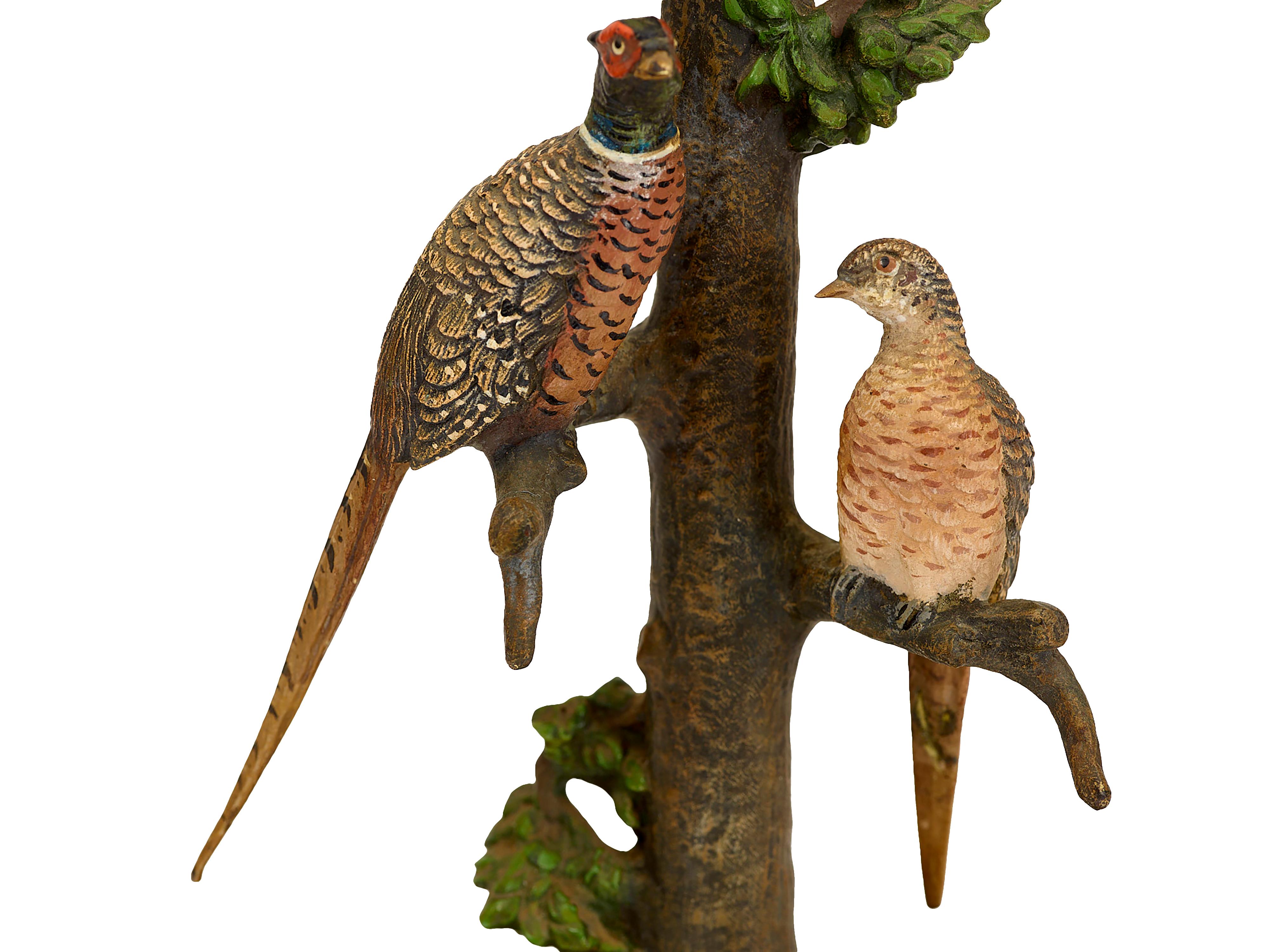 Cold painted Vienna bronze lamp supports on onyx bases
Depicting a pair of cock and hen pheasants, and a pair of budgerigars in trees. 
H 25, w 12.5, d 12 (each). Circa 1900. Germany