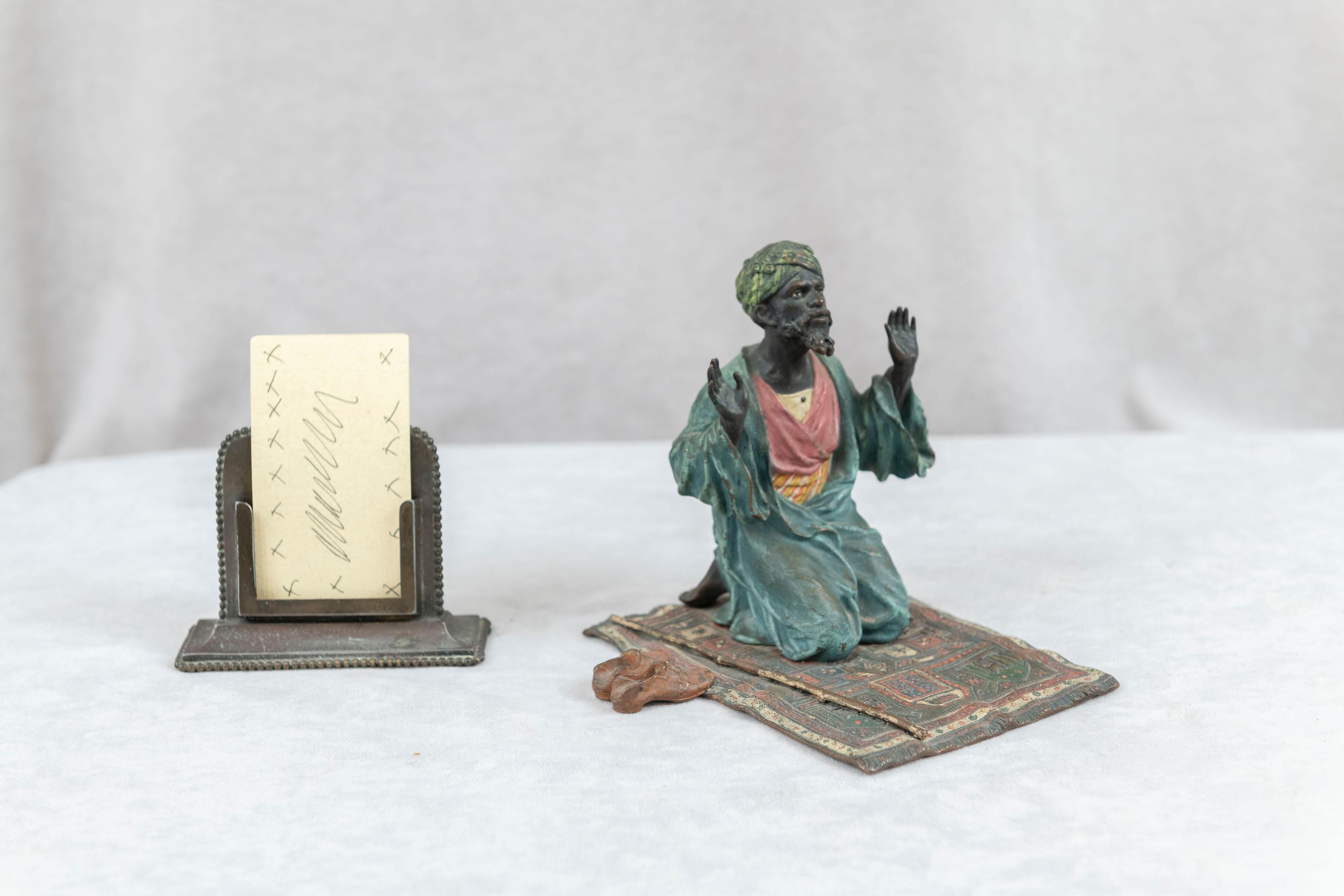  This very detailed Vienna bronze was made by the premier foundry of this genre, Franz Bergmann, and does bear his seal on the underside of the rug. The man praying is delicately painted and finely cast. His little shoes on the side of the rug are