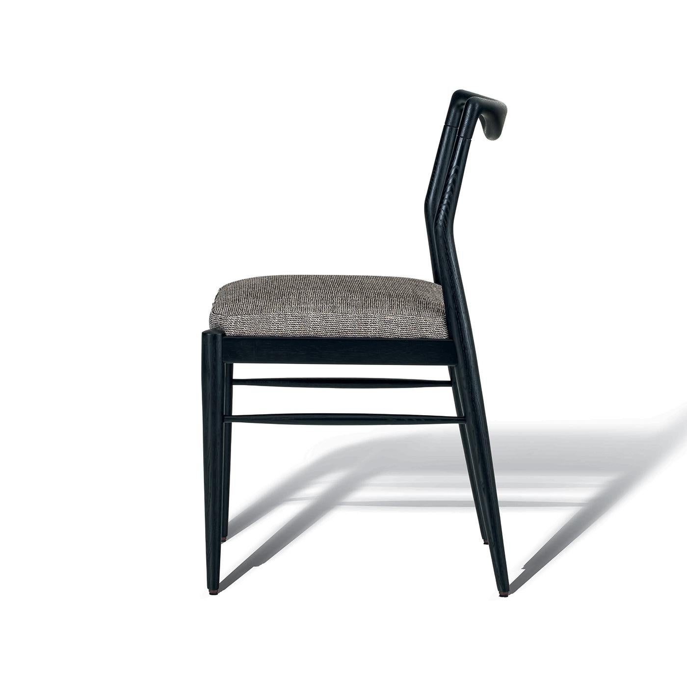 Modern and elegant, this chair features a solid wooden frame made of natural oak, ebonized oak or sucupira. The seat is characterized by a high density padded wood panel structure and by non-removable fabric or leather upholstery. This item can be