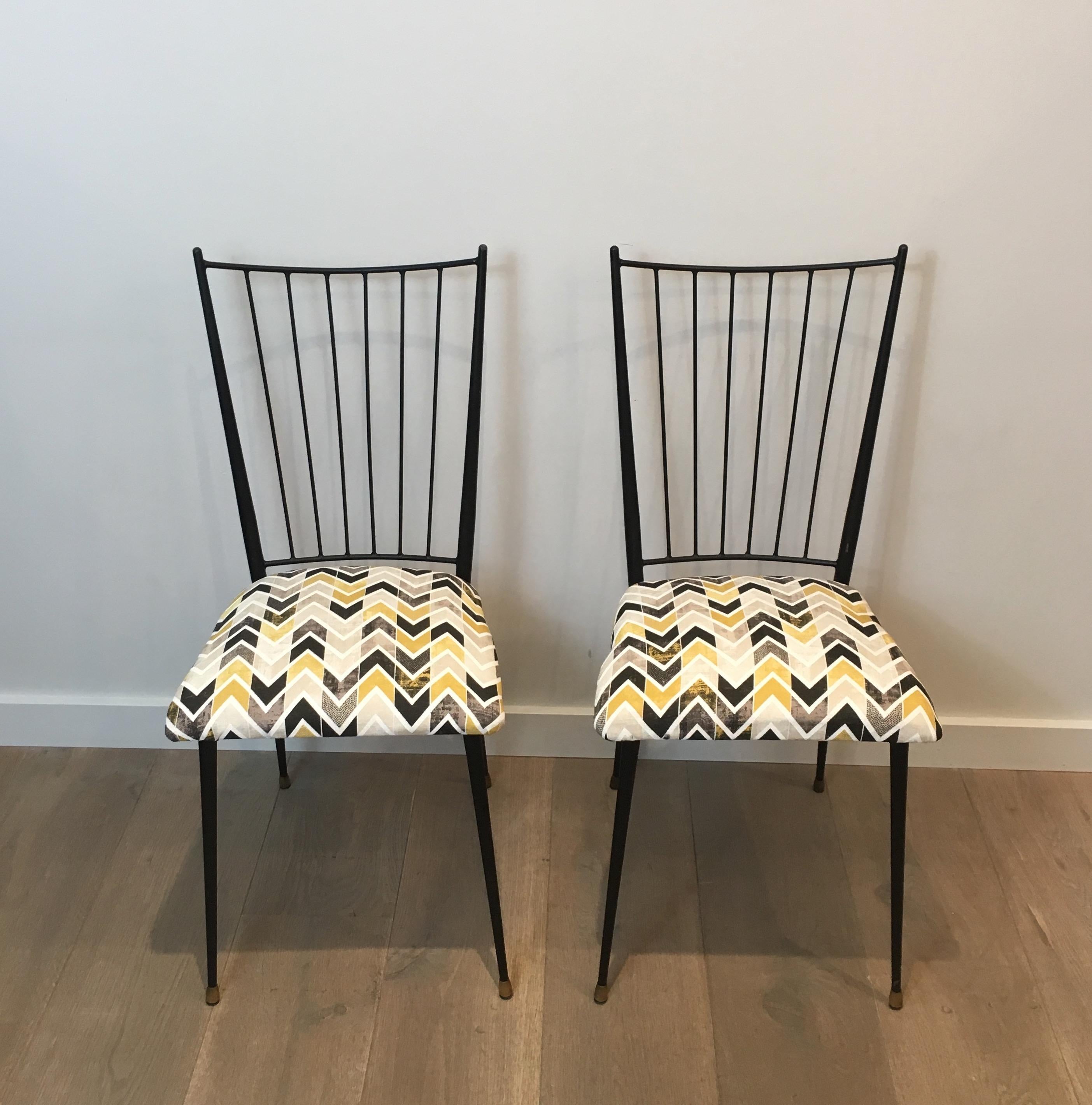 This nice pair of design chairs is made of a black lacquered metal with a nice fabric on the seat. This is a model by famous French designer Colette Gueden, circa 1950.