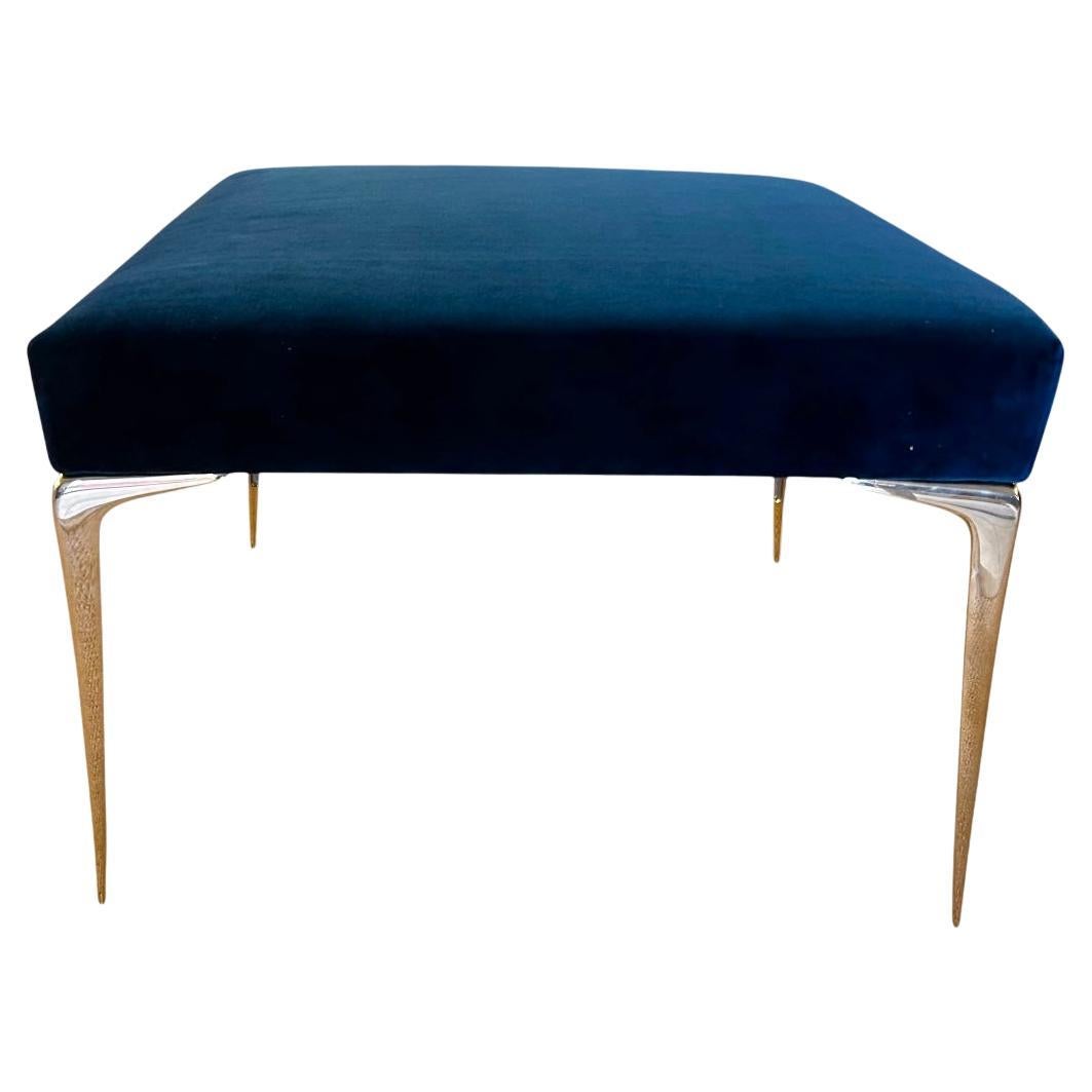 Designed by Montage, the customizable Colette Ottoman in Navy Blue Velvet is a classic and wonderful addition to a refined interior space. The solid brass tapered Stiletto leg is Italian in origin, completely cast and polished in the USA. Shown with