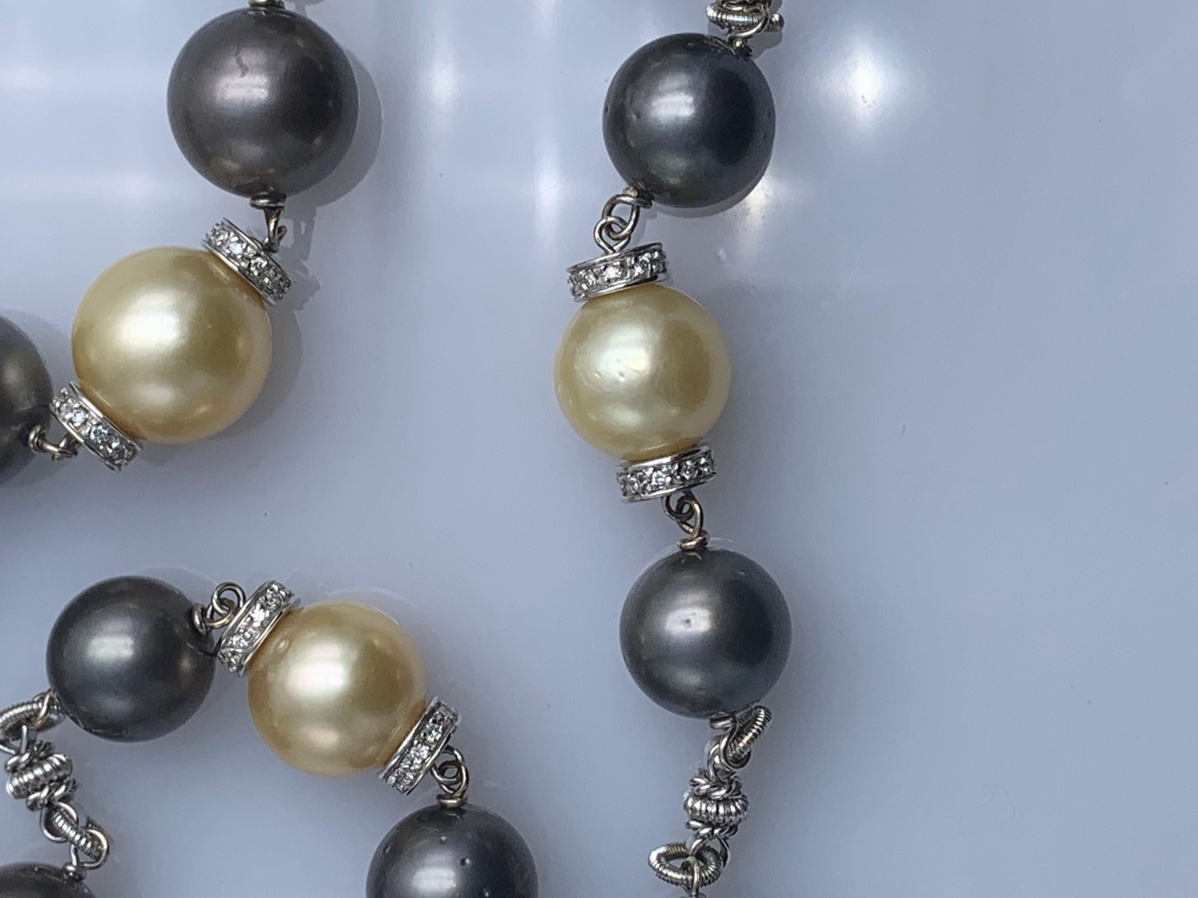 White gold necklace characterized by  13 cultured South Sea pearls of coloro gold millimeters 12 by Ct. 171.00  and 26per pearl black thaiti 12 mm for Ct 321. . Placed on the sides of the gold beads are two white gold washers with diamonds totaling