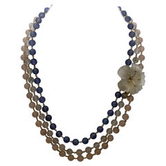 Multi-strand necklace with flower clasp.