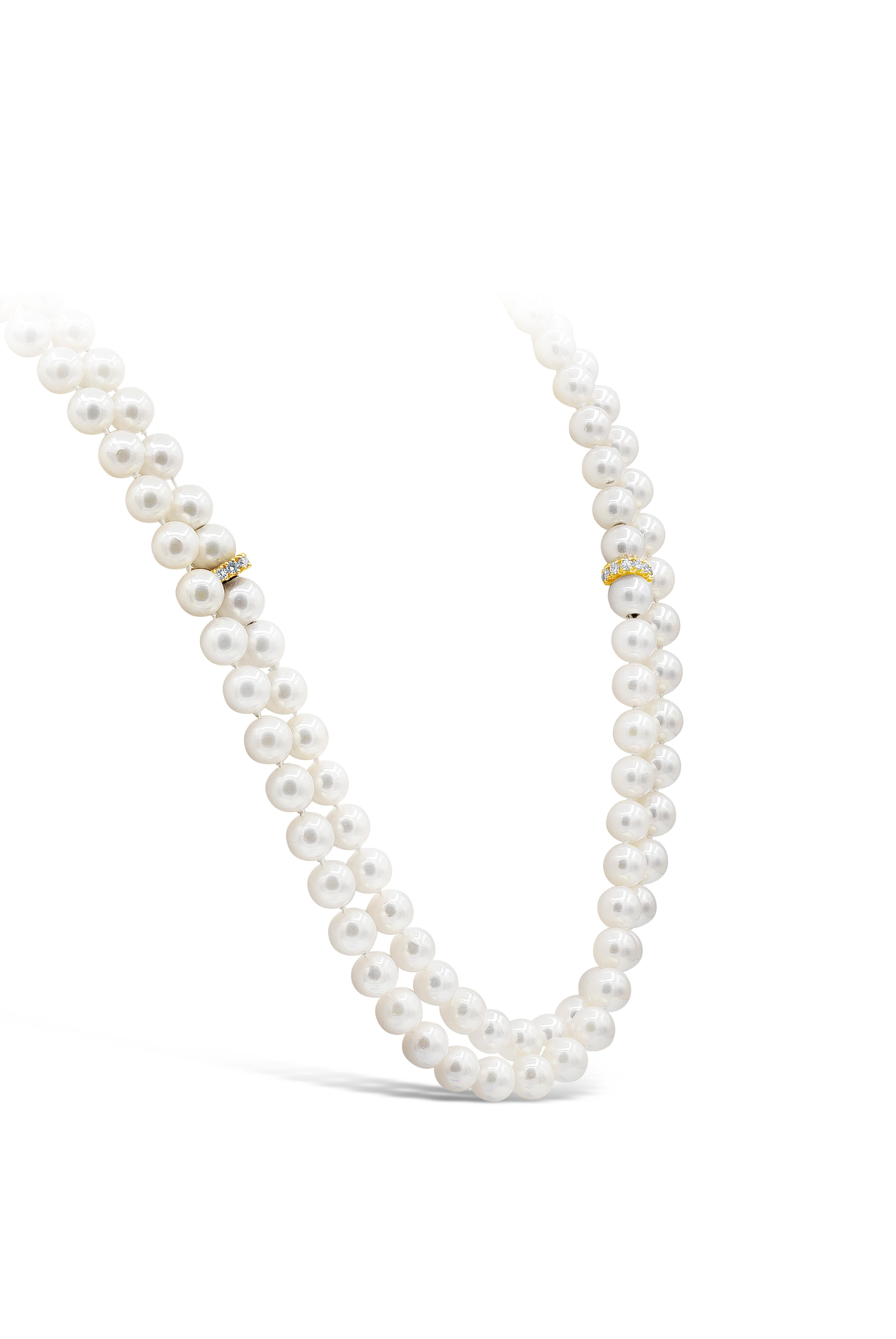 A unique and beautiful pearl necklace showcasing two separate strands of pearls that can be worn independently. It can connect to form into one long necklace. Each strand is spaced by a disc set with round diamonds weighing 1.00 carats total. Pearls