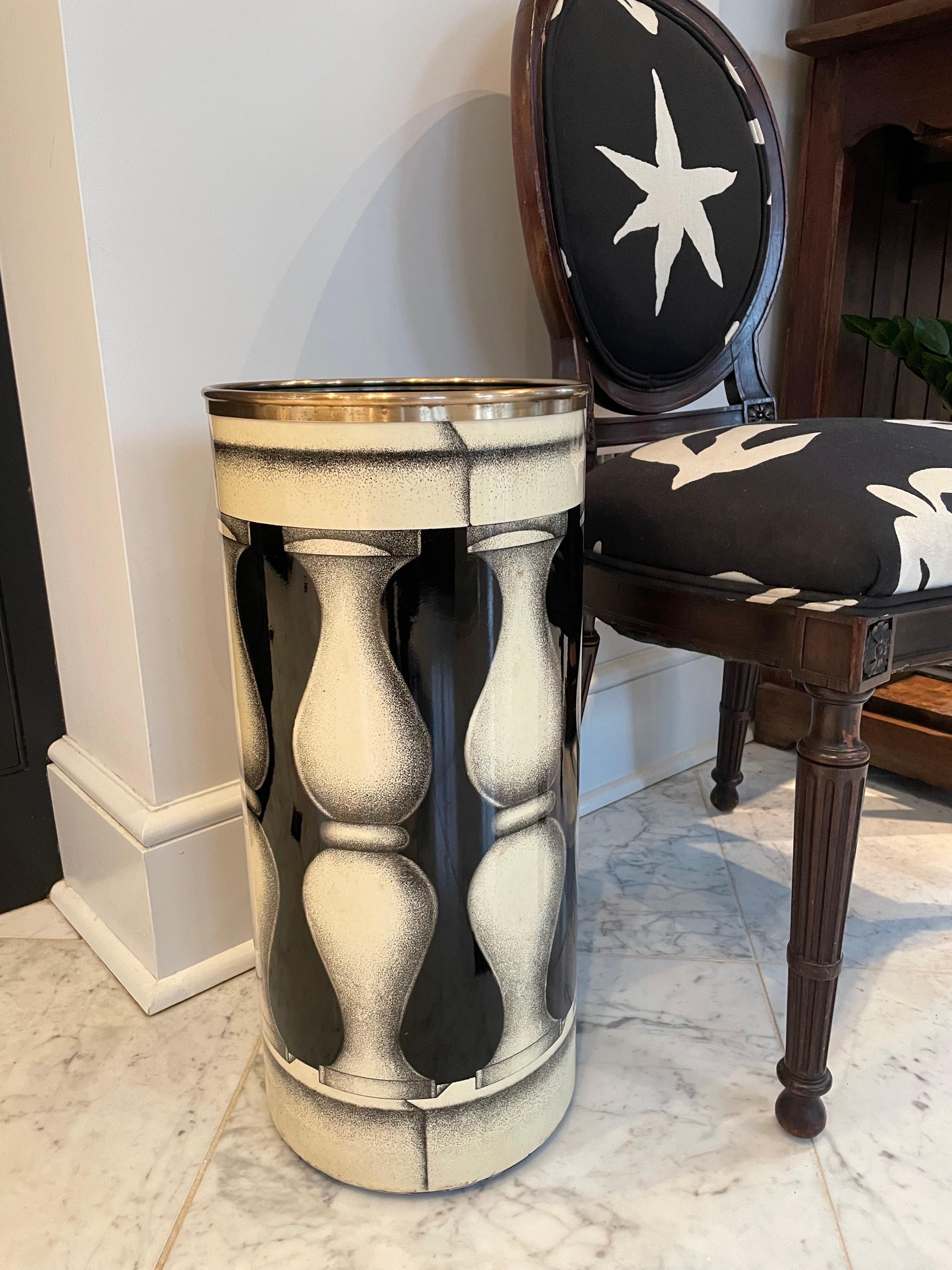 Very handsome and rare umbrella or cane stand by the iconic Piero Forrnasetti circa 1960 in Italy. The black and off white stand has a brass band around the top which creates a lip; this is a feature only found in early models. The striking baluster