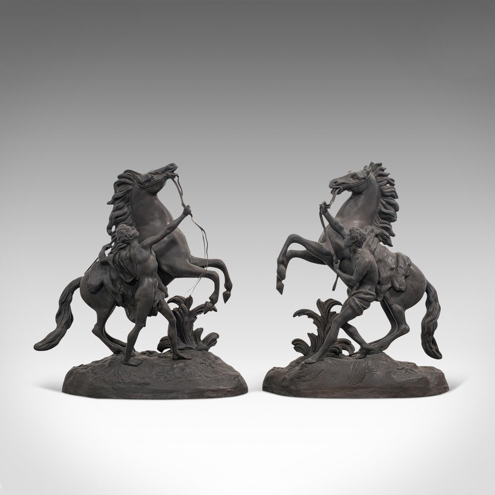 This is a dashing, collectible antique pair of Marly horses. A French, bronze equine statue in the manner of Guillaume Coustou (1677-1746), dating to the late 19th century, circa 1900.

Excellent representations of the famous Marly horses, on