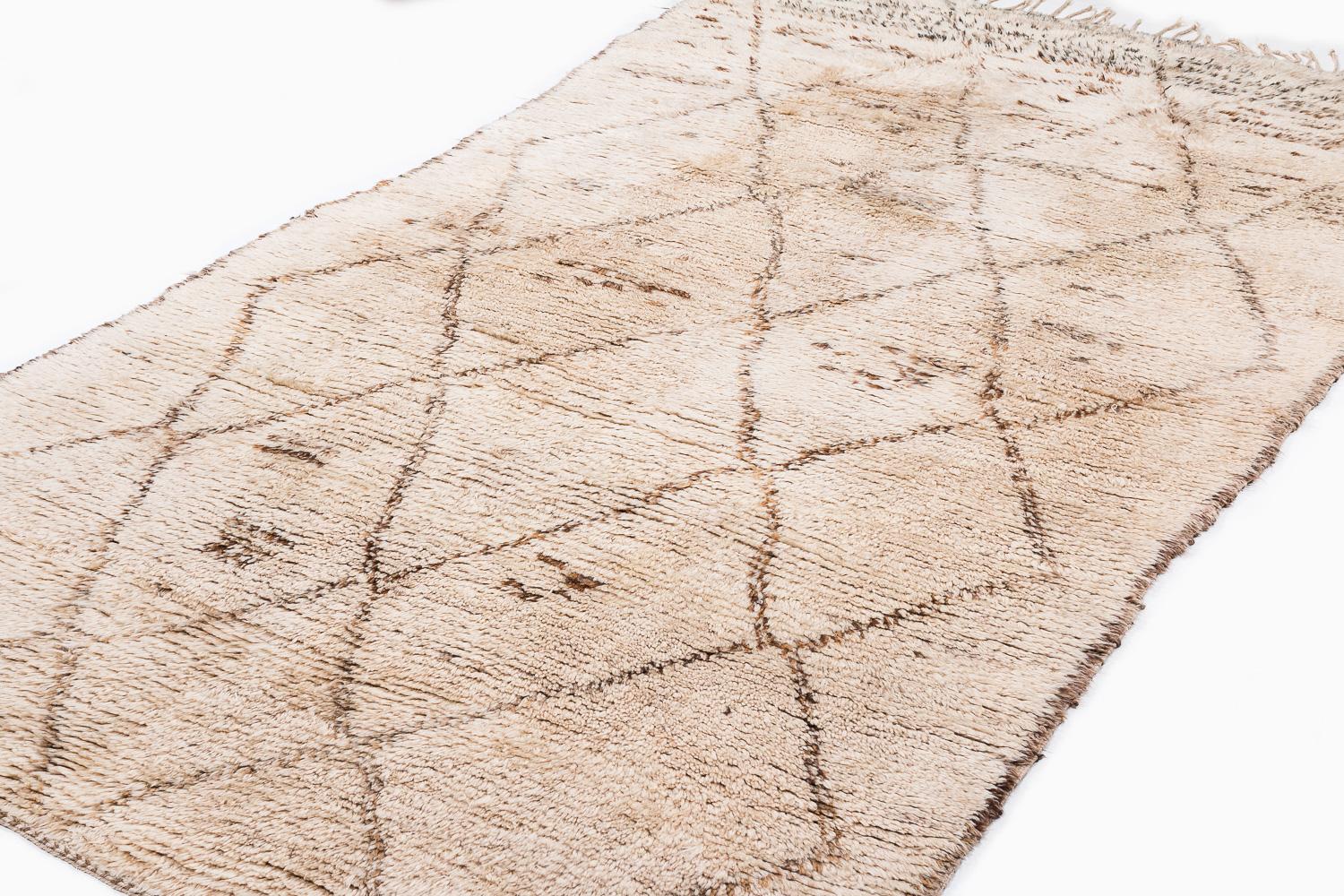 A rare collectible Moroccan antique vintage shag rug. Made by the Beni Ourain tribe in the central middle Atlas mountains. Beautiful natural creamy white wool with natural brown details forming a traditional diamond, crosshatch design. The