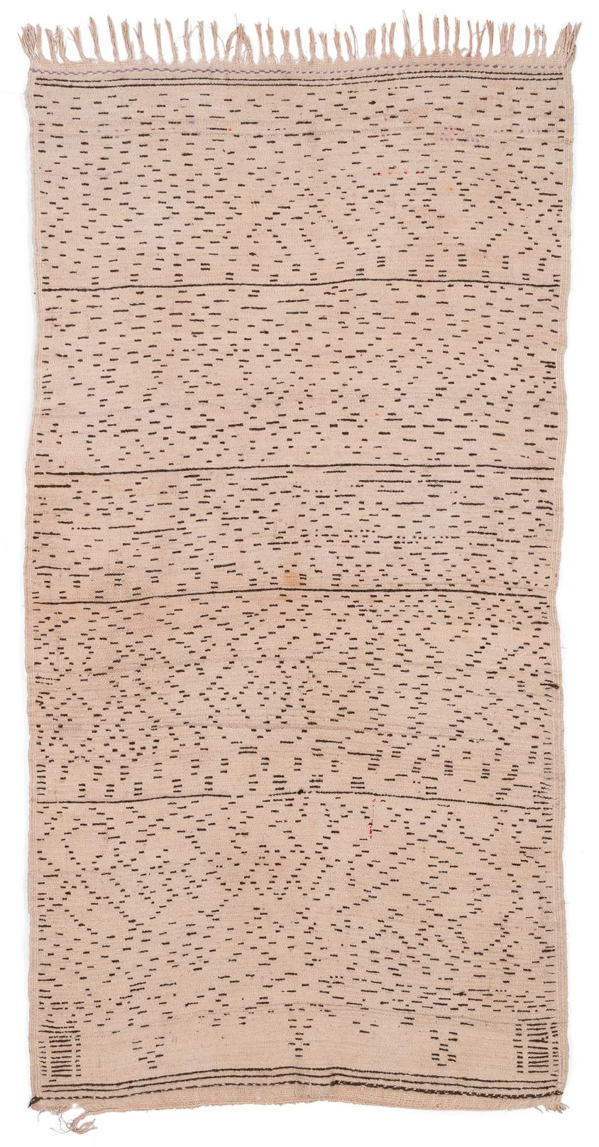 A rare collectible Moroccan antique vintage shag rug handmade by the Azilal tribe of the high Atlas mountains. Beautiful natural creamy white wool with natural brown details forming an almost animal print design. The irregularity of the pattern make