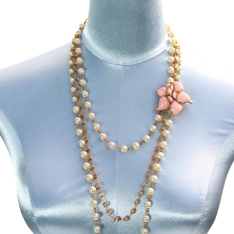  Collectible Augustine Gold Tone Pink Flower Pate De Verre Necklace Free form flower sits on the middle of three rows of faux pearls, larger and smaller and crystals. Neck portion is 20