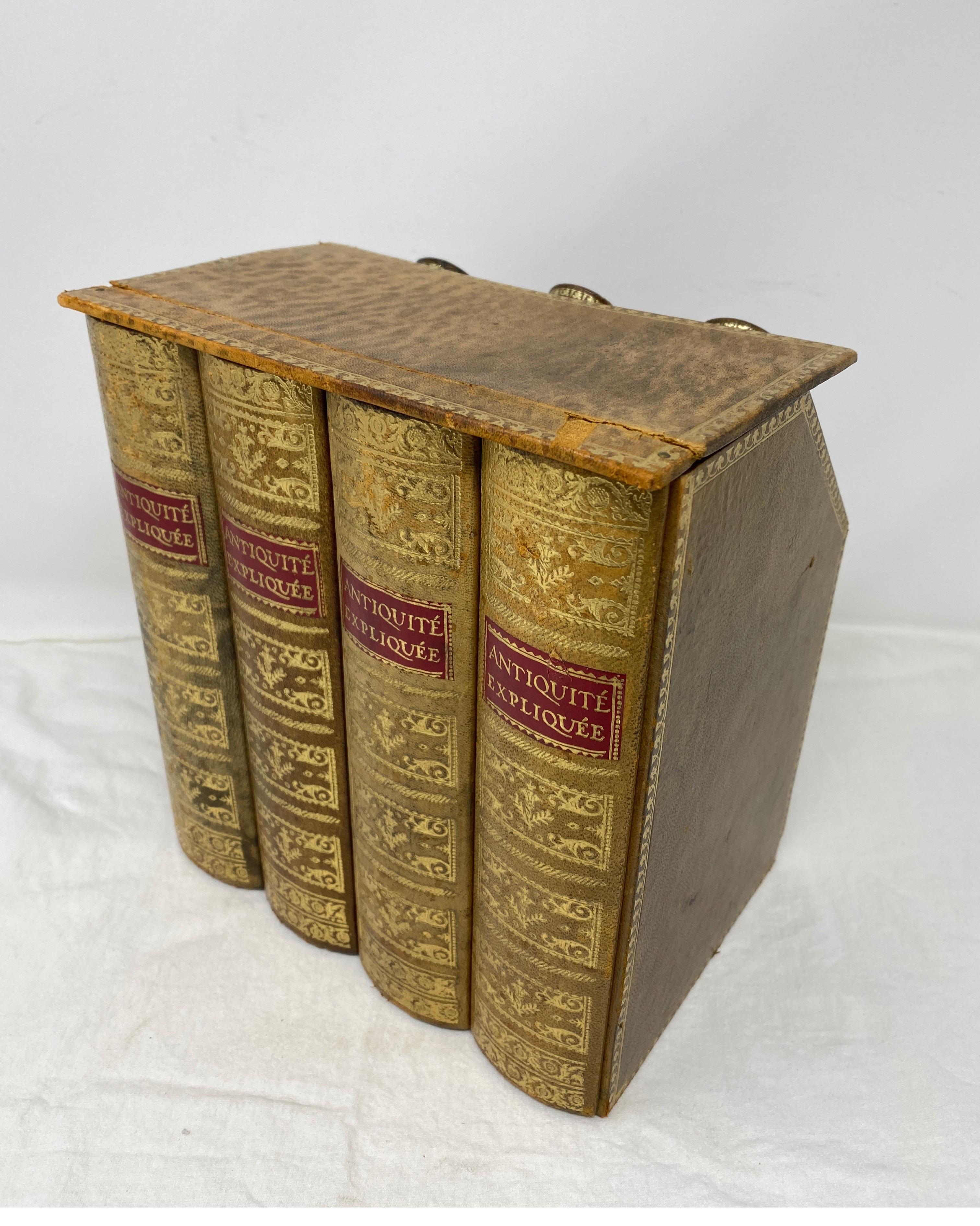Collectible faux books with hidden flasks. The faux books reveal three amber colored bottles typically used to conceal alcohol. The back side has the words 