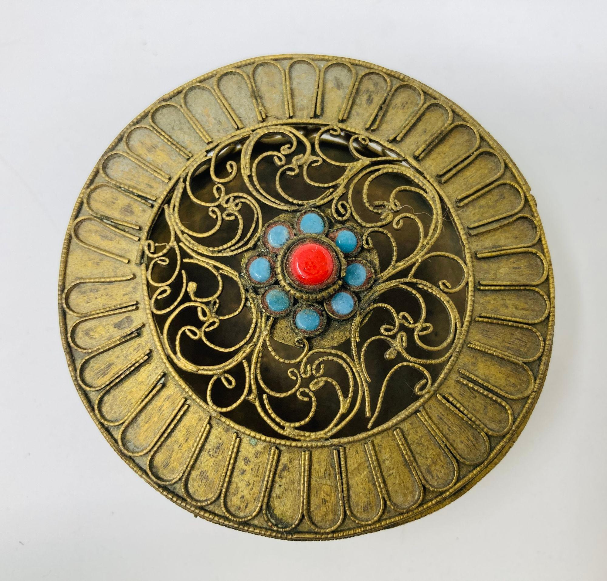 Collectible Chinese Tibetan Gilt Brass Metal Filigree with Turquoise and Coral beads round Box Handcrafted round Tibetan, Nepalese decorative brass trinket wish box with pull-off lid.
Antique gilt metal wish box. The round box is crafted in open