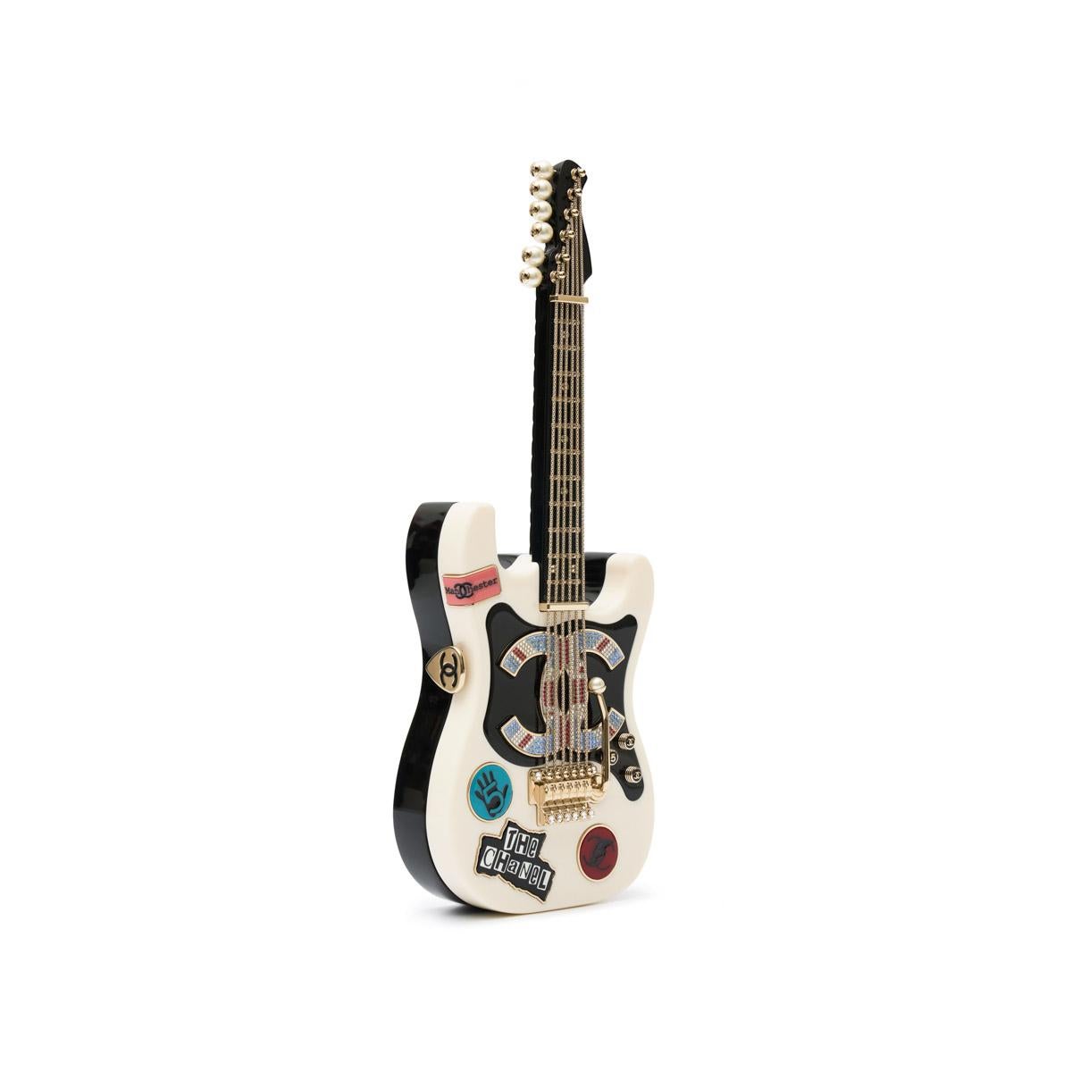 This Chanel Métiers d'Art Collectible Guitar Minaudière Clutch Bag is a rare find for fashion collectors and luxury handbag enthusiasts. A true statement piece, this designer collectible is both stylish and functional, perfect for those who