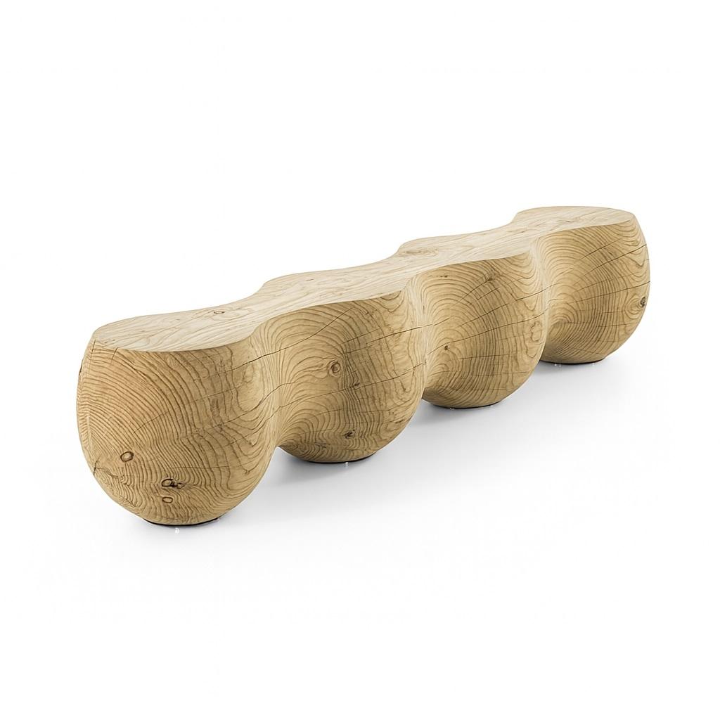 This unique bench, carved from a single block of solid cedar of Lebanon wood, features a harmonious series of four spheres that evoke the organic shape of a caterpillar. The design highlights a striking contrast between solid and open spaces, giving