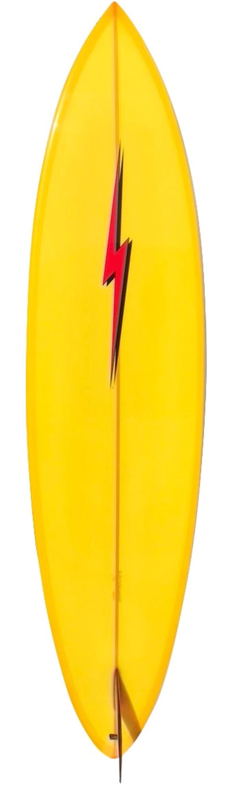Collectible lightning bolt single fin surfboard shaped by Craig Hollingsworth. Features a rounded pintail shape with double pin line design and glassed on red single fin. A great example of a classic 1970s-style Lightning Bolt shortboard