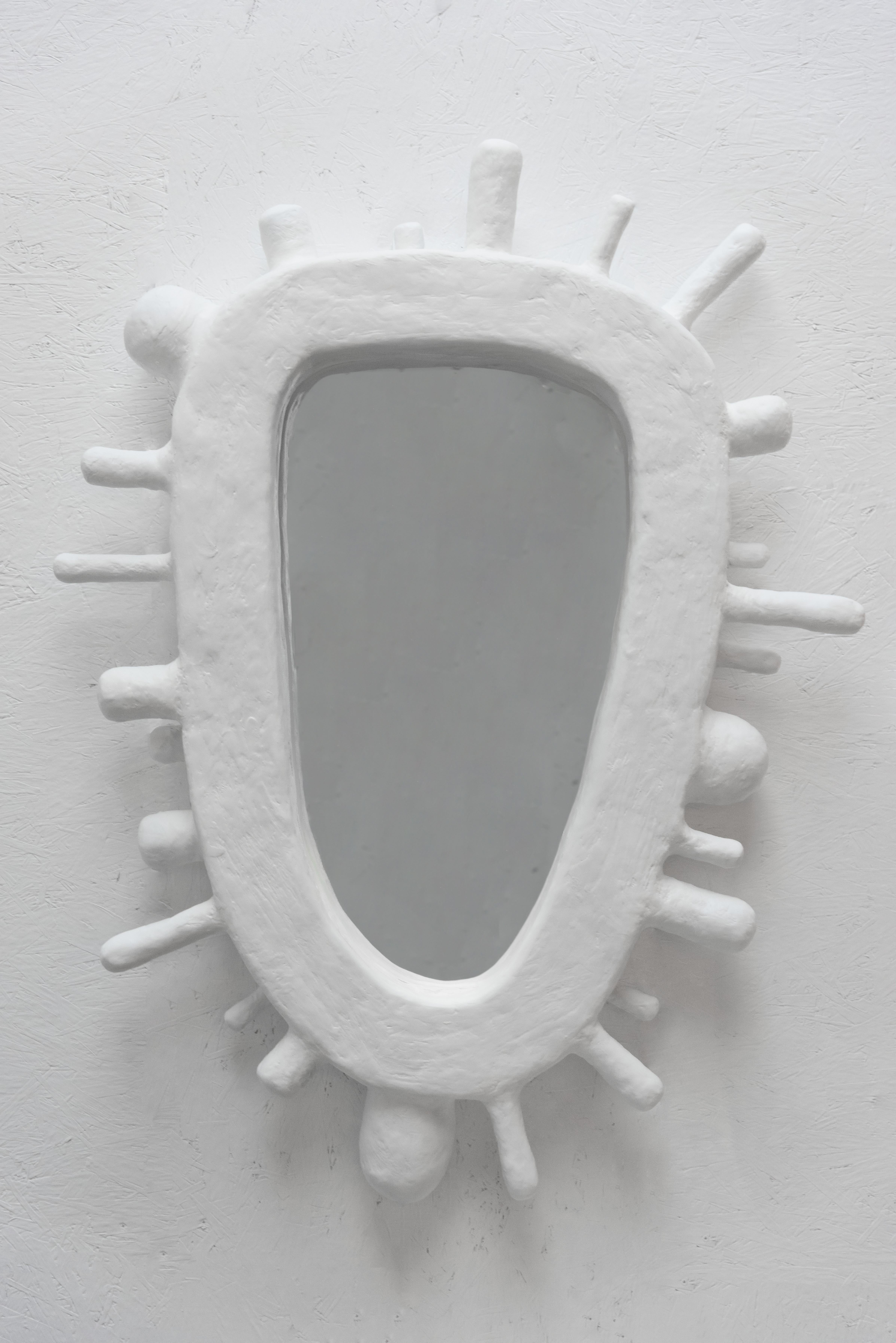 Inspired celestial beings, radiating beams, and 16th century French headpieces, the Nimbus Mirror serves as an exploration between humans and the heavens. 

Each piece is made to order and is available in white, black, cream, or custom colors.