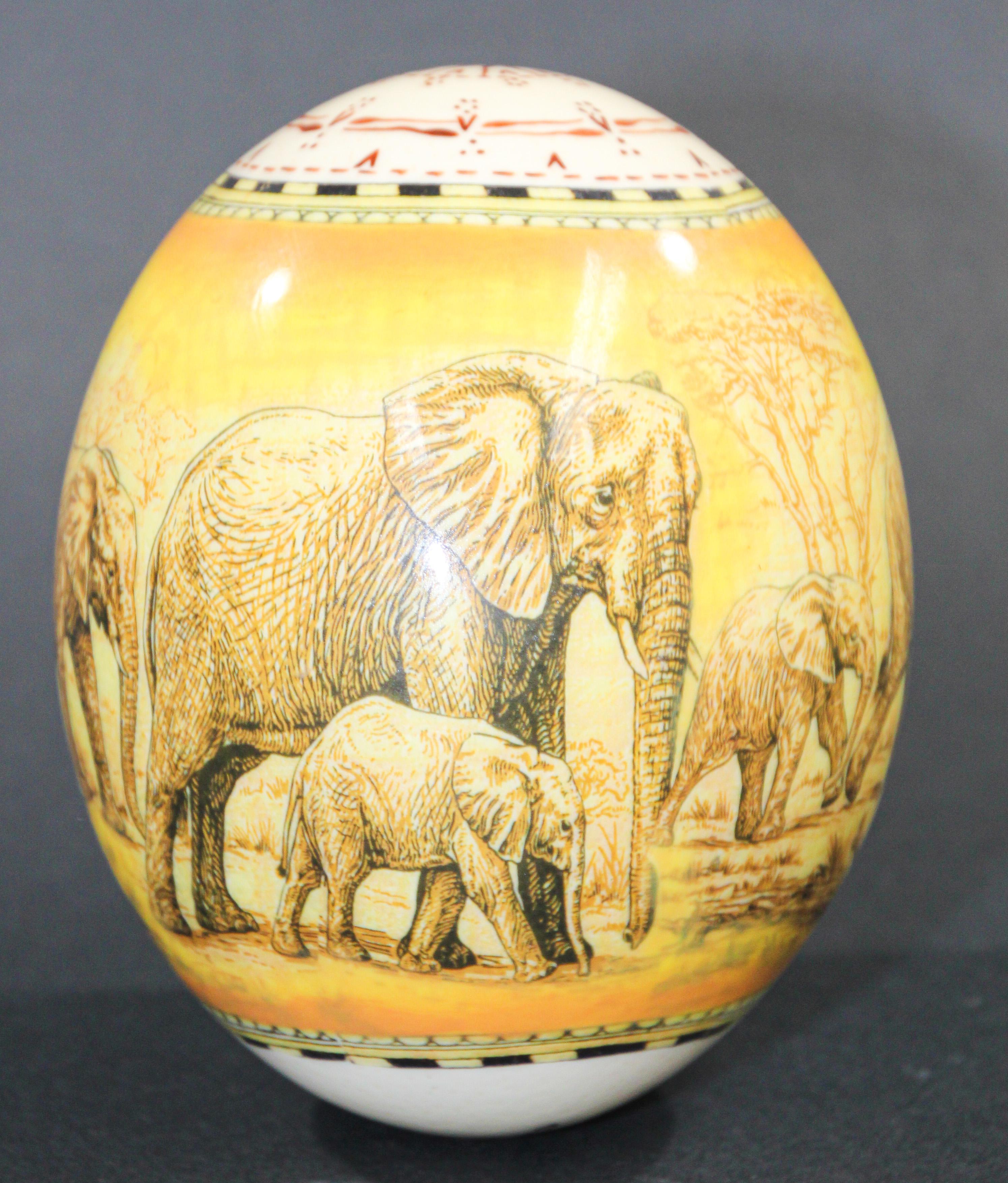 This beautiful scene of elephants painting on an ostrich egg shell is hand painted and signed by an African artist. 
A symbol of the source of life, this collectable Ostrich egg is a coveted item for any collector. 
The wonderful coloration comes
