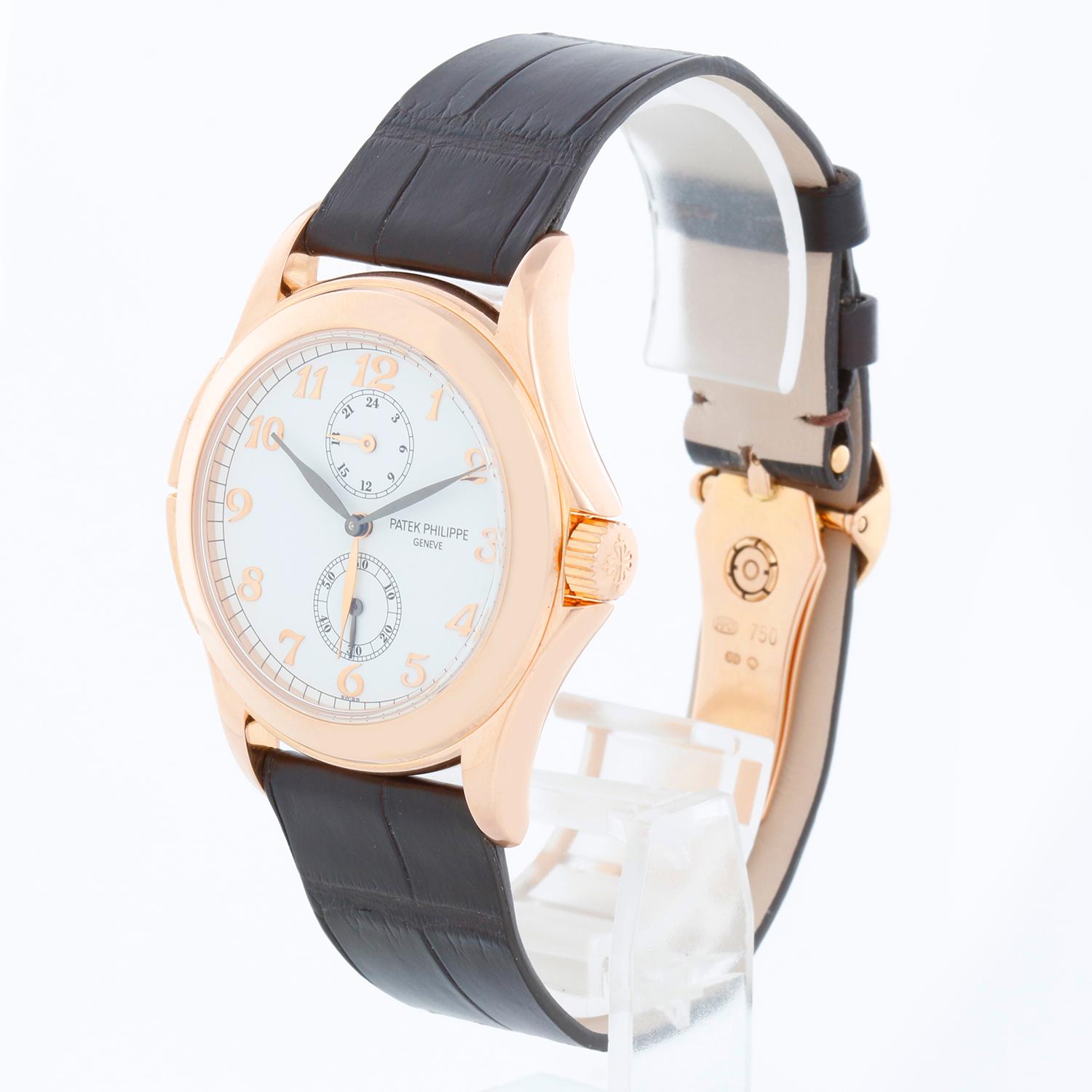 Collectible Patek Philippe Travel Time Men's 18k Rose Gold Watch 5134 R or 5134R - Manual winding; dual time. 18k rose gold case with exposition back (36mm diameter). White dial with rose gold raised numerals. Dark Brown aftermarket strap band; 18k