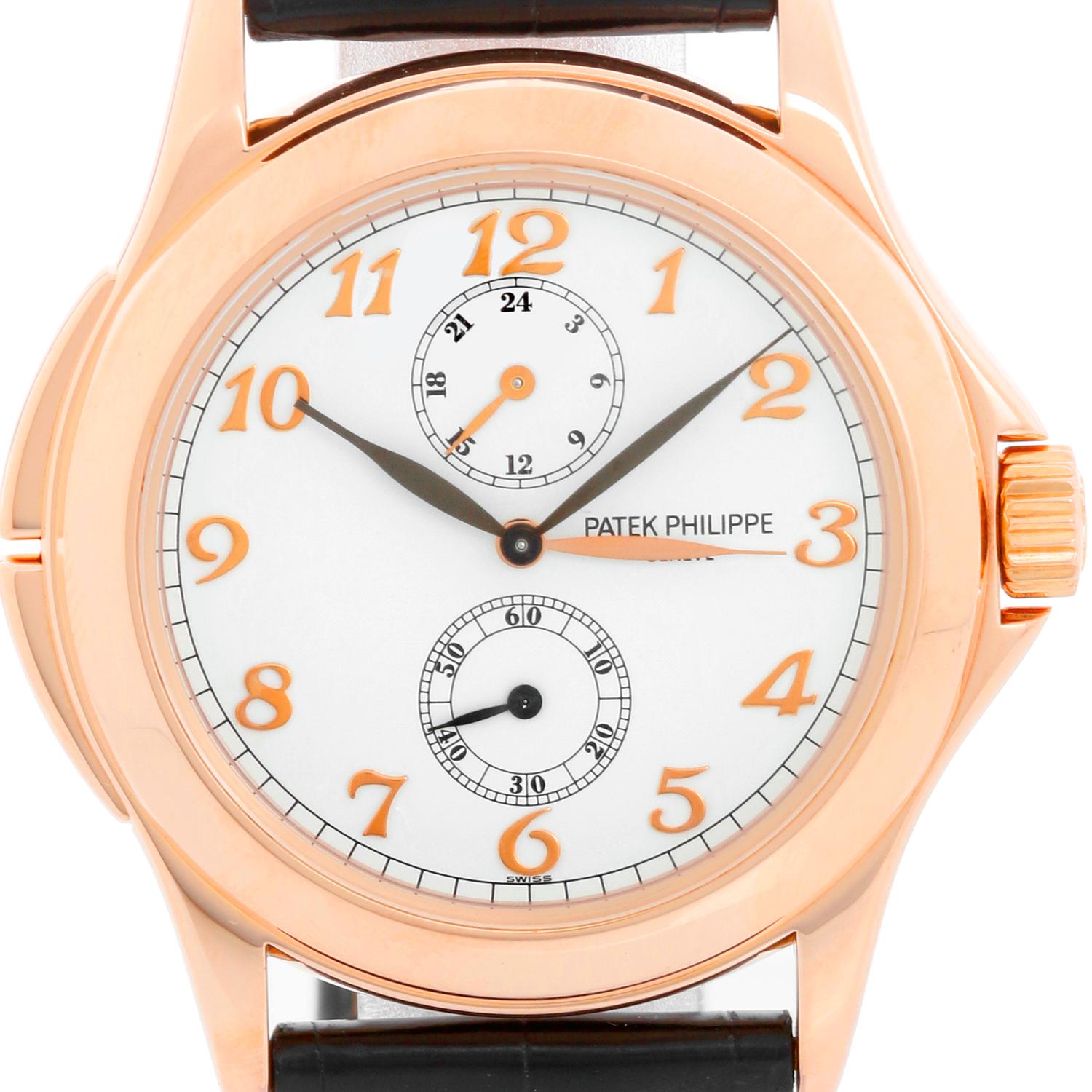 Collectible Patek Philippe Travel Time Men's 18k Rose Gold Watch 5134-R or 5134R - Manual winding; dual time. 18k rose gold case with exposition back (36mm diameter). White dial with Rose gold Breguet numerals. Patek Philippe strap band; 18k rose