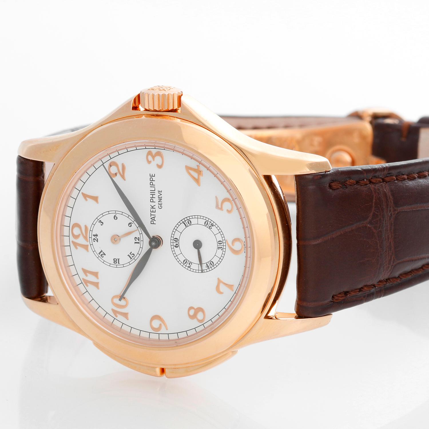 Collectible Patek Philippe Travel Time Men's 18k Rose Gold Watch 5134 R or 5134R - Manual winding; dual time. 18k rose gold case with exposition back (36mm diameter). White dial with rose gold Breguet numerals. Patek Philippe strap band; 18k rose 