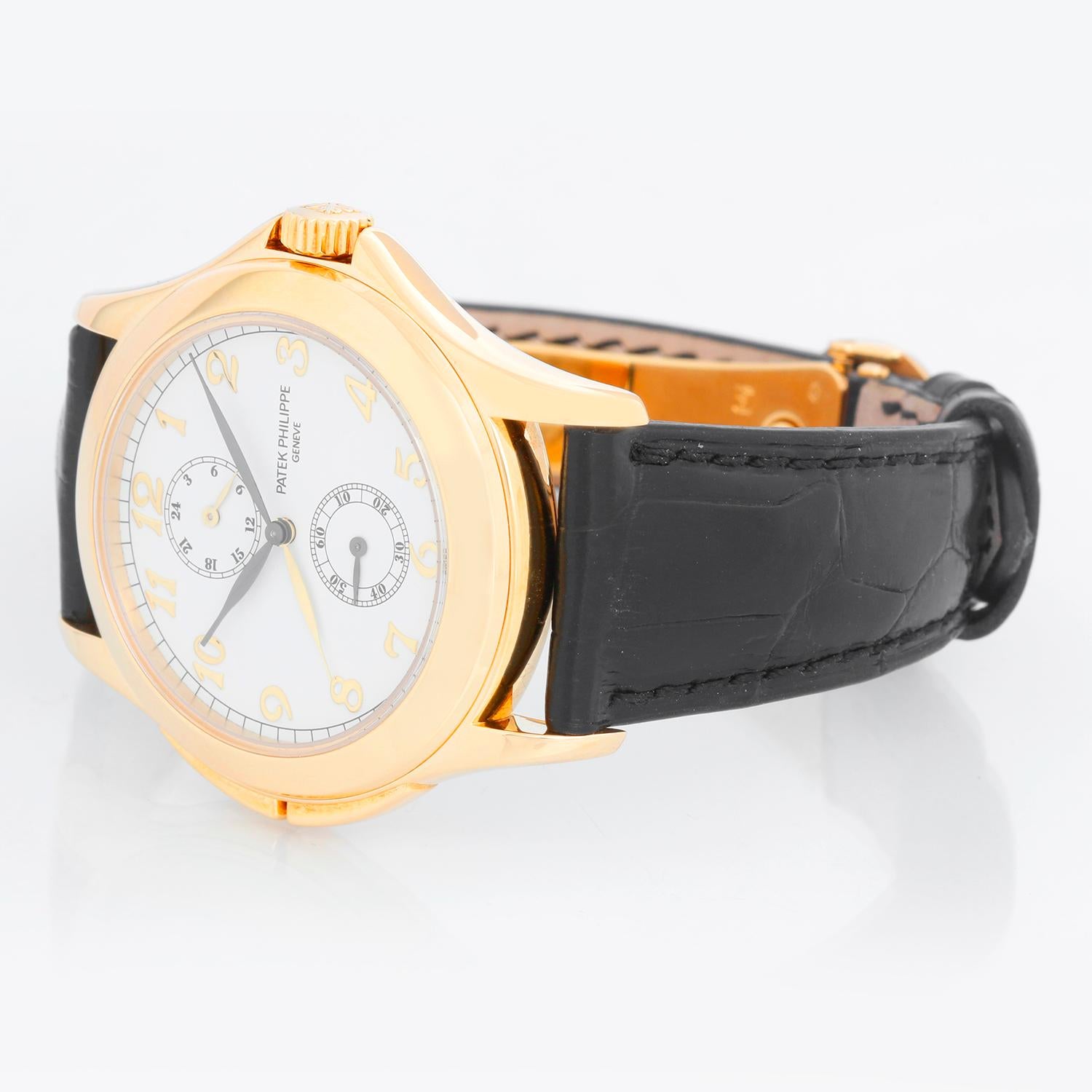Collectible Patek Philippe Travel Time Men's 18k Yellow Gold Watch 5134-J or 5134J - Manual winding; dual time. 18k yellow gold case with exposition back (36mm diameter). White dial with yellow gold Breguet numerals. Patek Philippe strap band; 18k