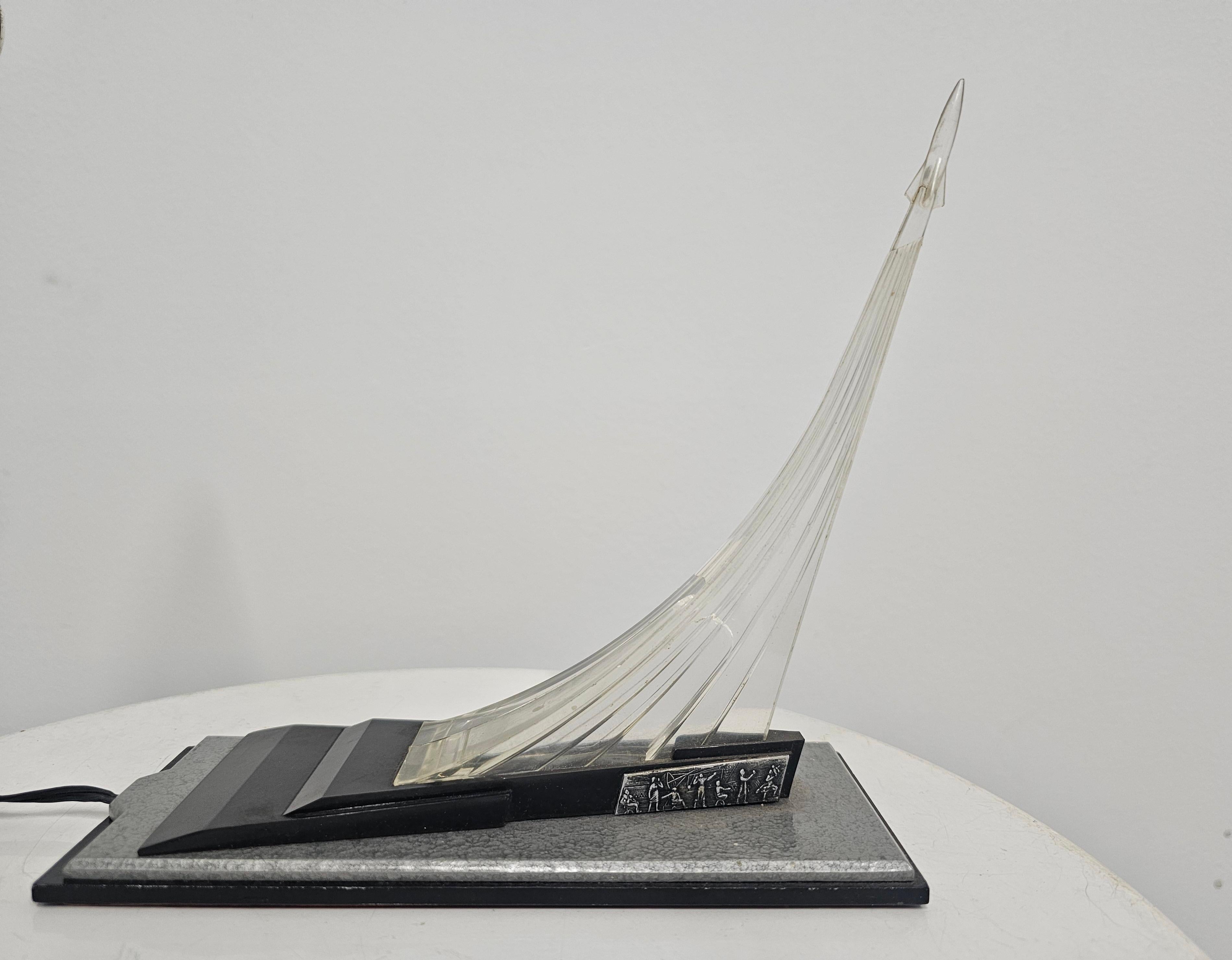 In this listing you will find a rare Soviet table lamp, which was designed to commemorate the explorstion of space. It was made in Soviet Russia, after the Monument of the Conquerors of Space, an obelisk in Moscow, dedicated to exploration of space