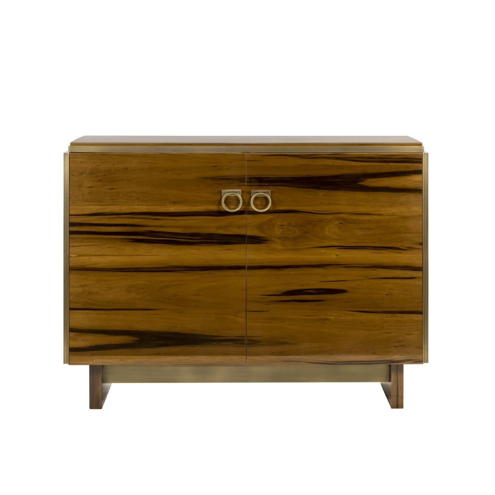 This elegant two-door cabinet is a beautiful example of modern design and functionality. It has a striking, luxurious presence, with a beautiful smoked satin walnut finish treated with a high-gloss lacquer. This rich finish gives the wood a deep,