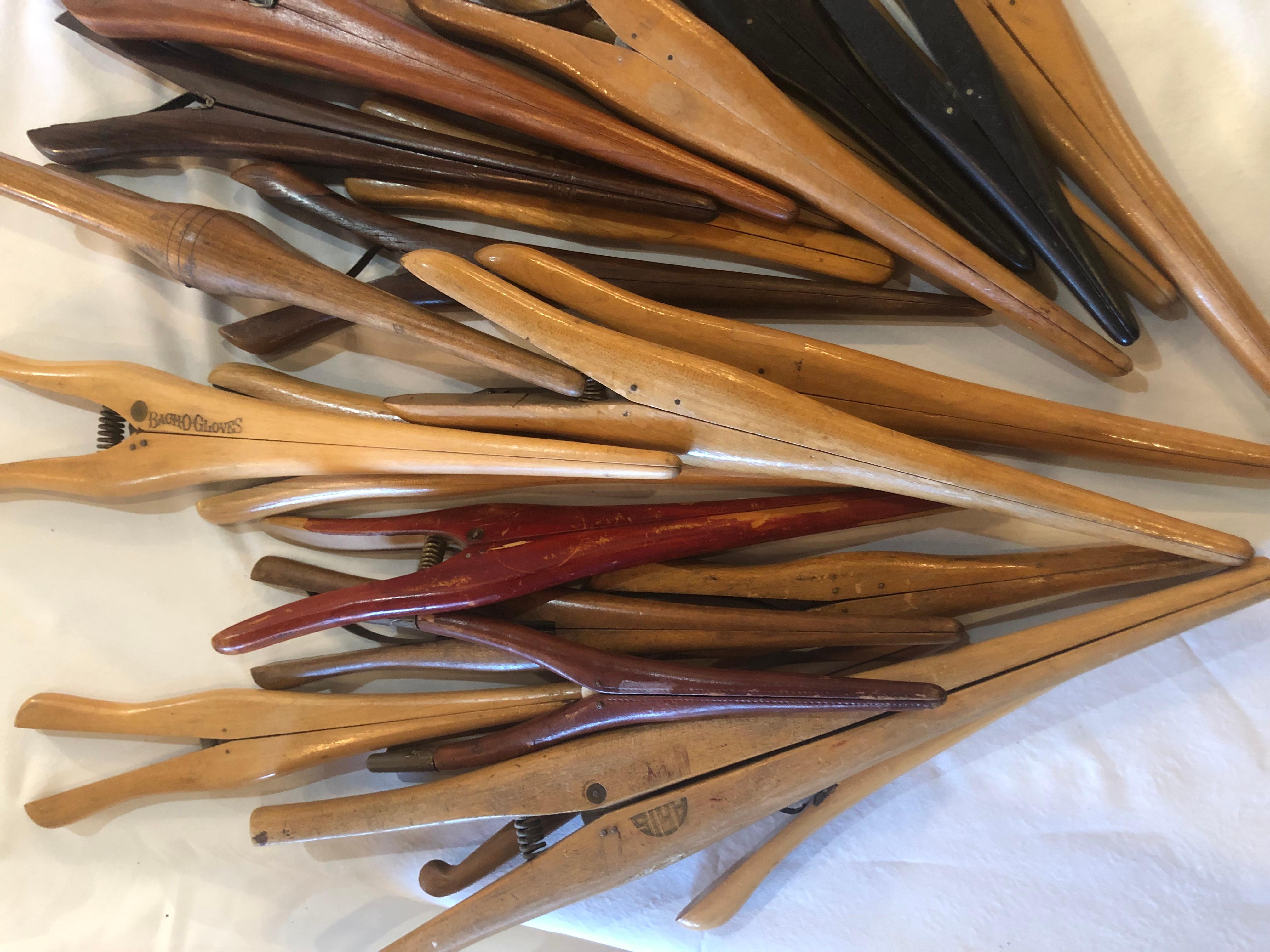 Collection of 24 wooden and colored antique spring action glove stretchers assorted manufacturers. The largest measures 14 inches, the smallest at 6 inches.