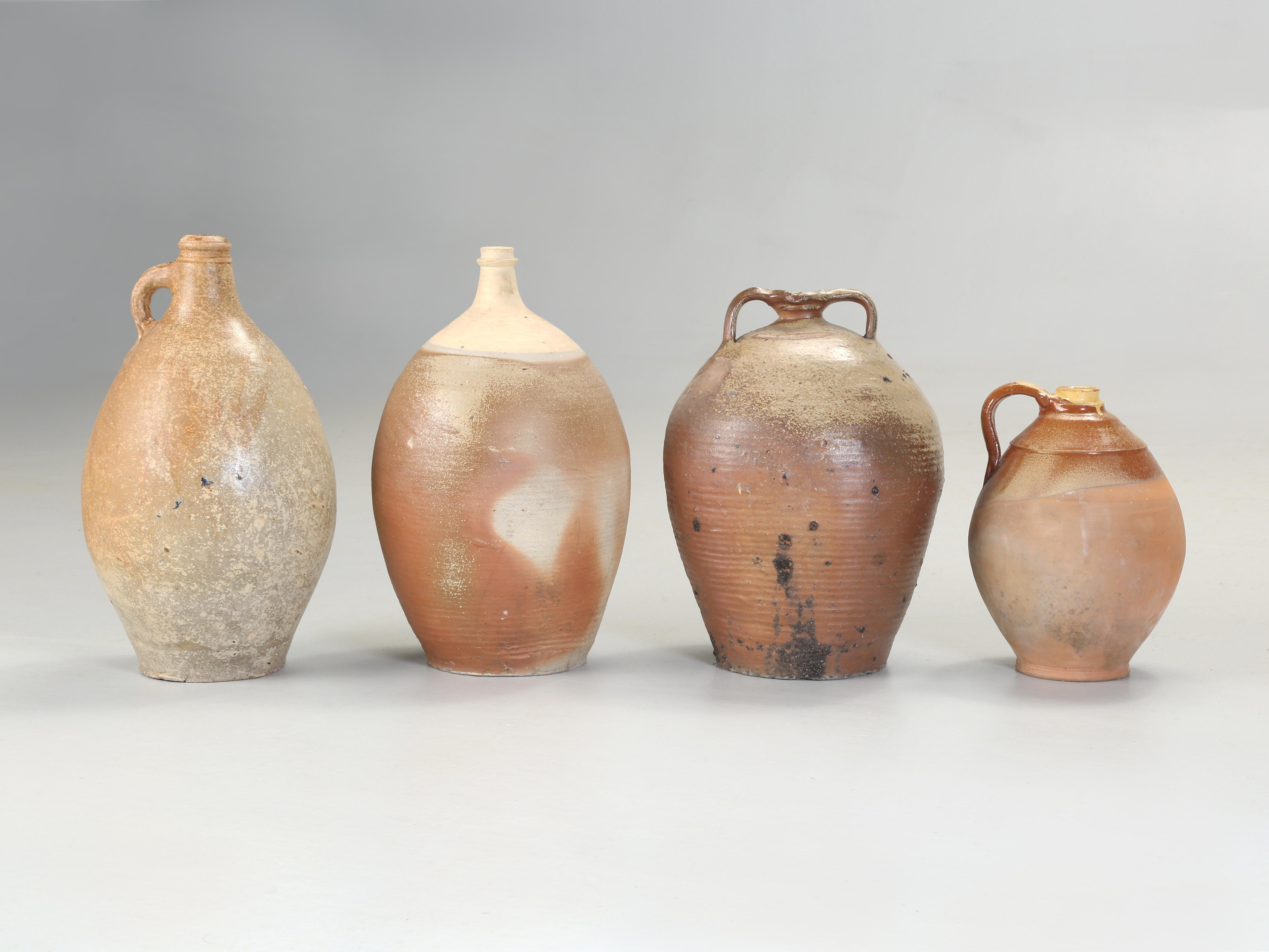 Collection of (4) beautiful Antique French Stoneware Pottery Jugs from the early 1900's purchased in Provence Region of France. Typically these were used to transport walnut oil or water and make for wonderful decorative objects. 119
Measurements