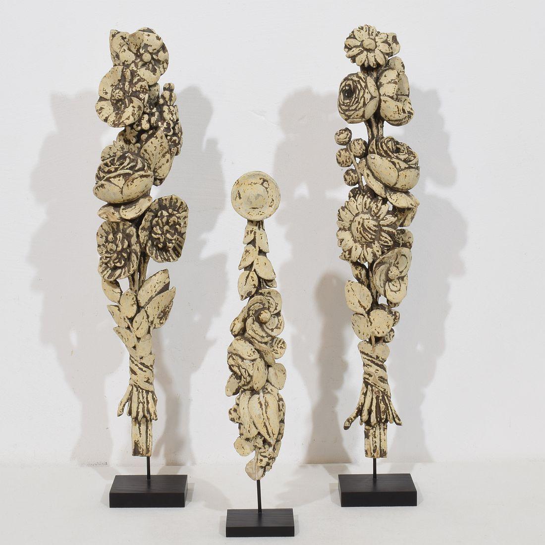 Beautiful collection of three  18th century neoclassical carved wooden ornaments.
France circa 1780.
Weathered, small losses
Measurements are individual and include the wooden base.
H:39-54,5cm  W:6-10cm D:6-7cm 