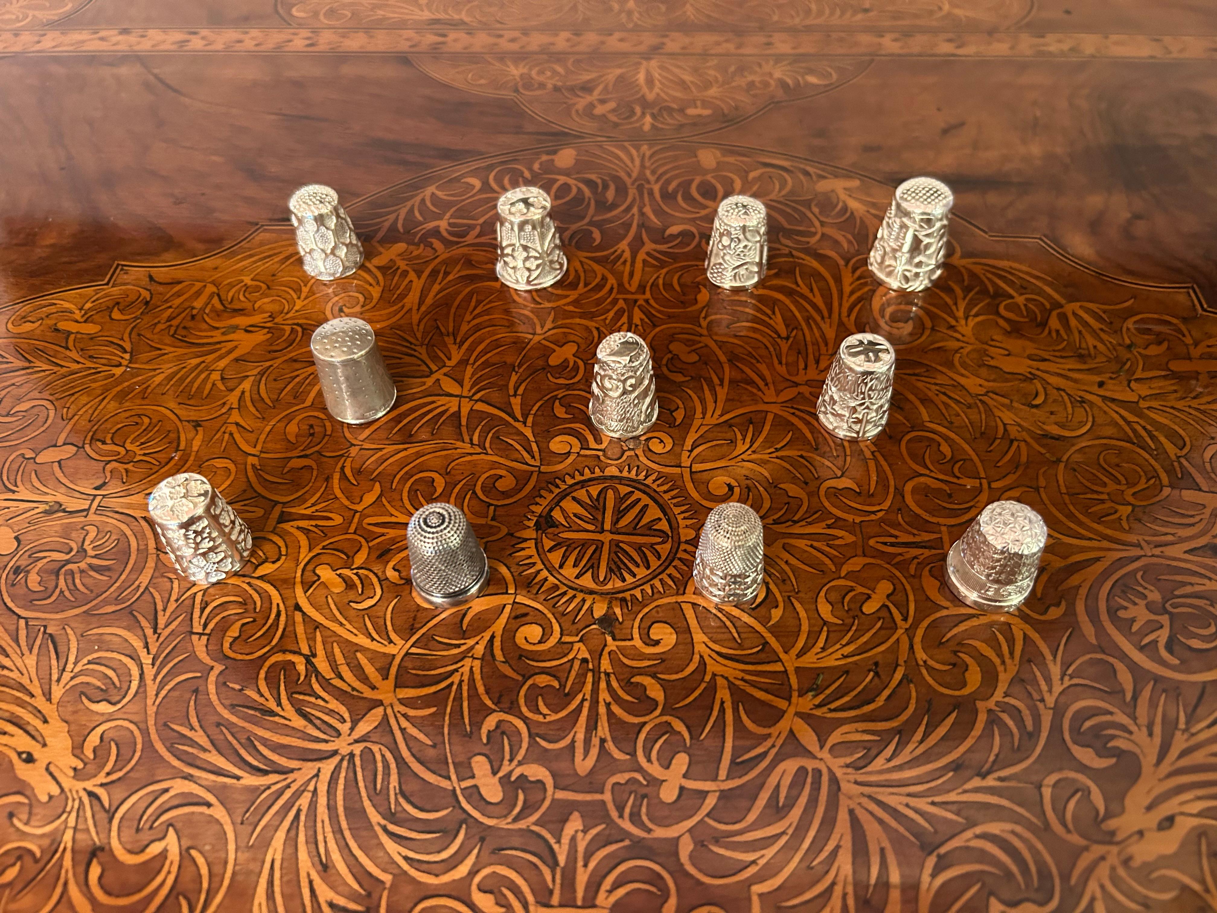 A wonderful collection of 11 English silver thimbles, raging from early nineteenth century to twentieth century.
The largest one measuring 1