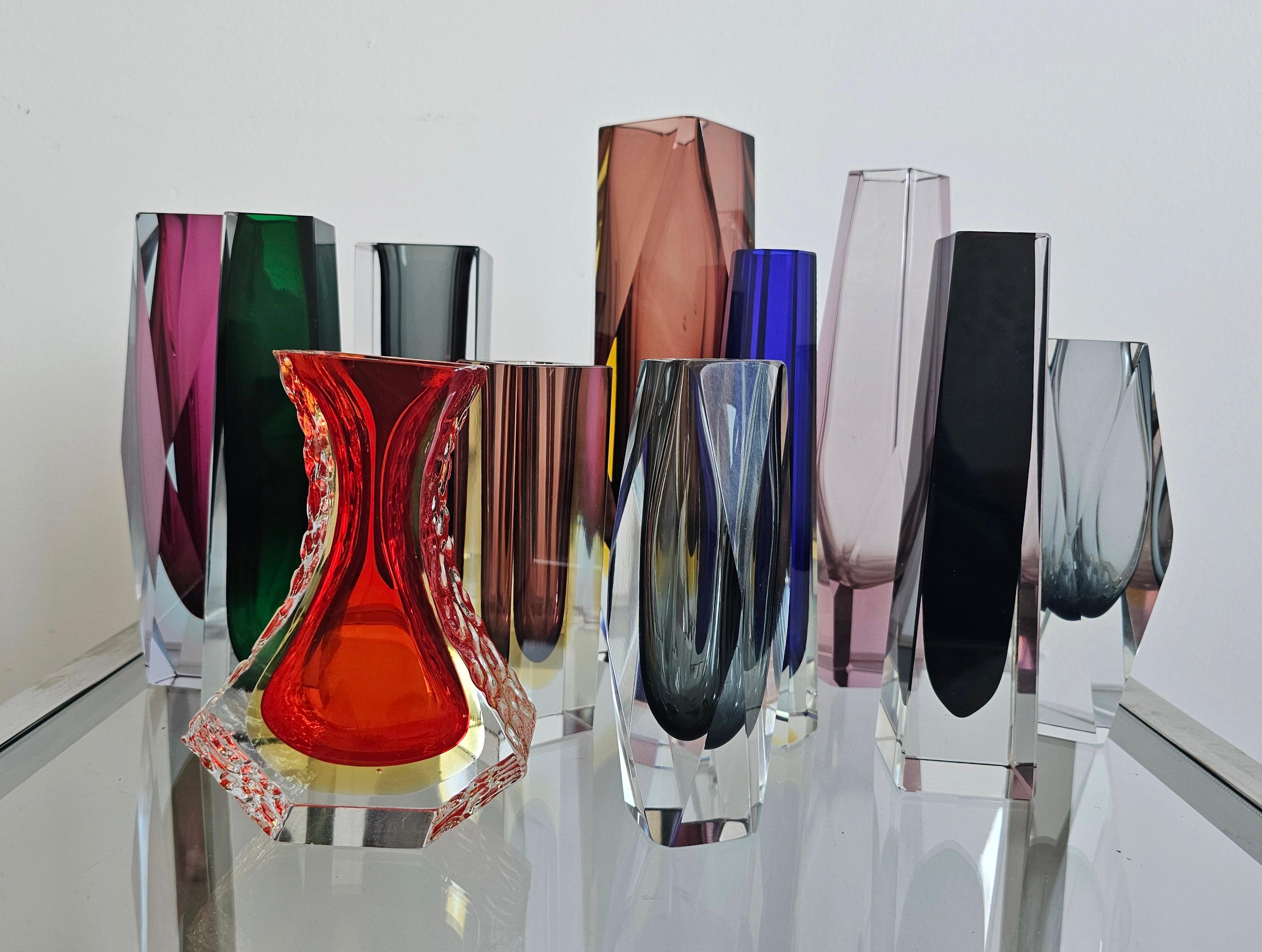 In this listing you will find a collection of 11 Mid Century Modern Sommerso glass vases, designed by Alessandro Mandruzzato. All of them were made of Murano glass and are featuring various colors, shapes and sizes. Put all together, they look