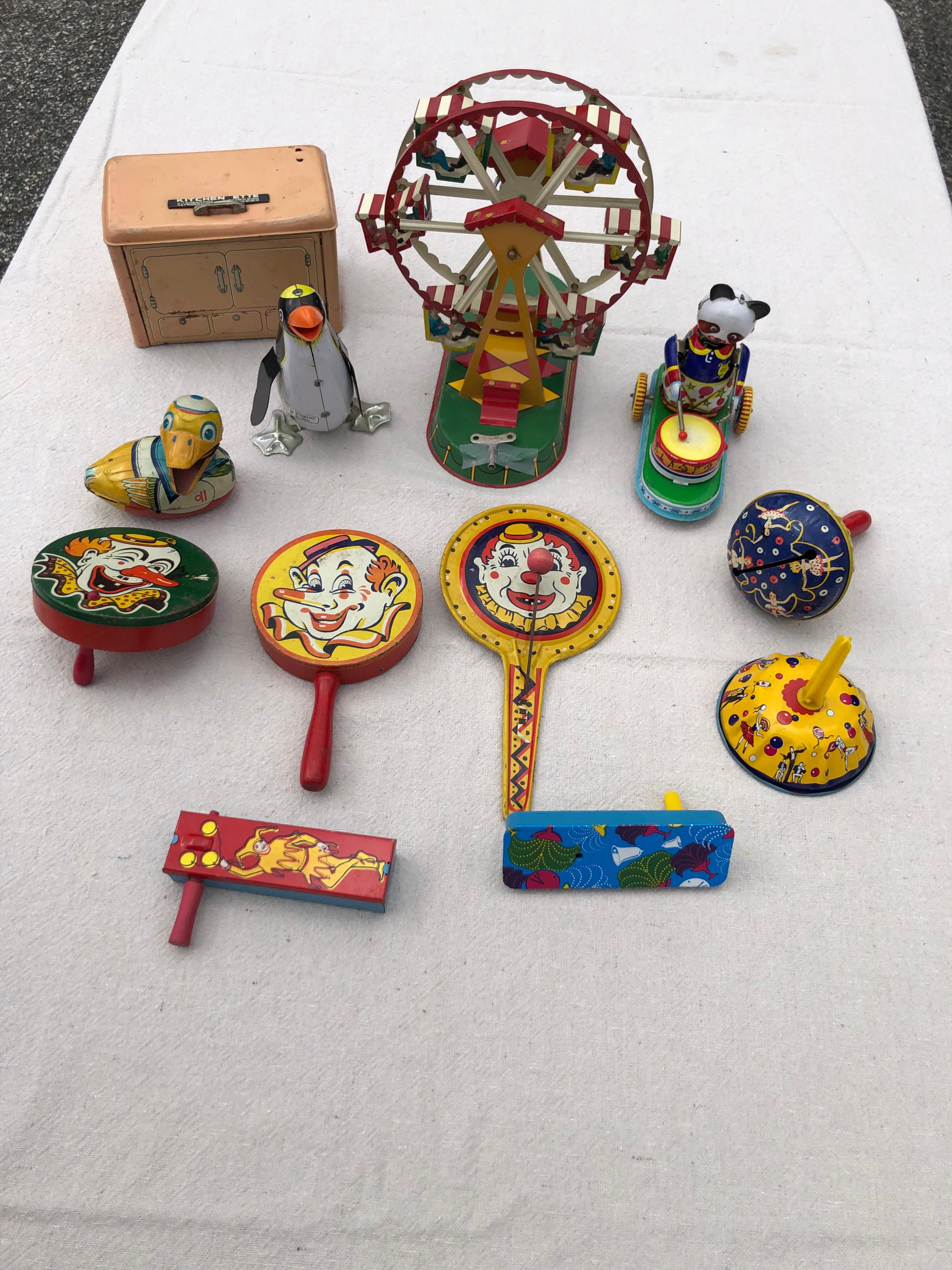 Collection of 12 vintage tin lithograph lithograph toys. $400 for the entire collection. Price is for the set, The set includes a German Ferris Wheel by Joseph Wagner which has the original key to wind it. 7 noisemakers, 3 wind up animals (penguin,