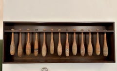 Collection of 13 Early 20th C. Juggling Pins in Wall-Mounted Display Box