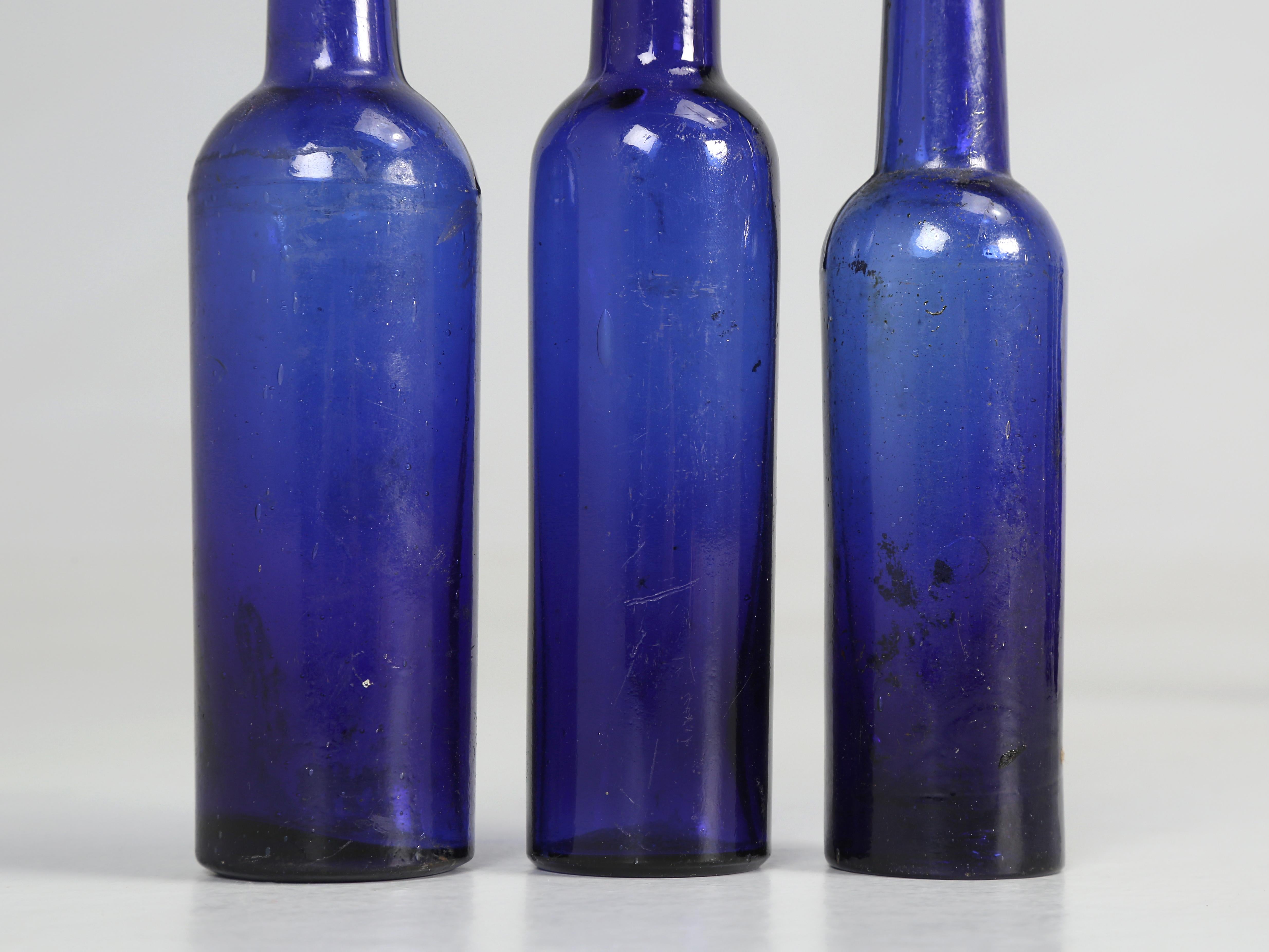 Glass Collection of '15' Cobalt Blue caster Oil Hand Blown Bottles Made in 1800s For Sale